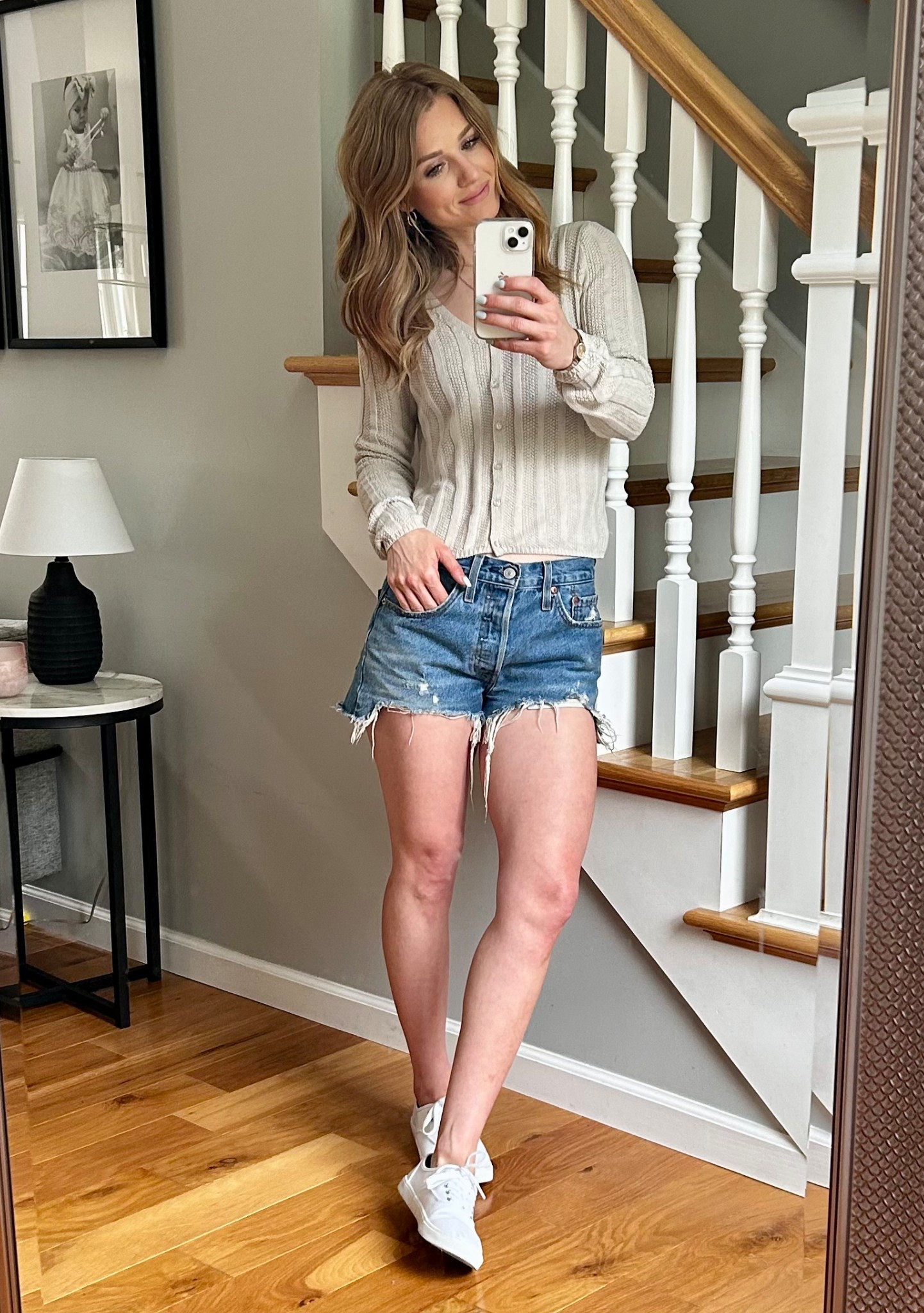 Casual Spring/Summer Outfit. Jean shorts with neutral colored sweater and white shoes. 