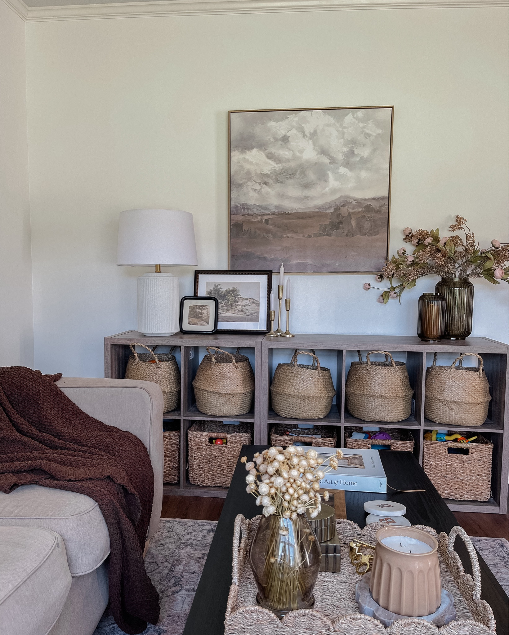 Playroom inspo. Fall decor in living room. Sitting room decor. Toy storage. Aesthetically pleasing playrooms. Cube storage ideas. Wicker backers. Coffee table decor. Table lamp. Console table styling ideas. 

#LTKKids #LTKHome #LTKSeasonal