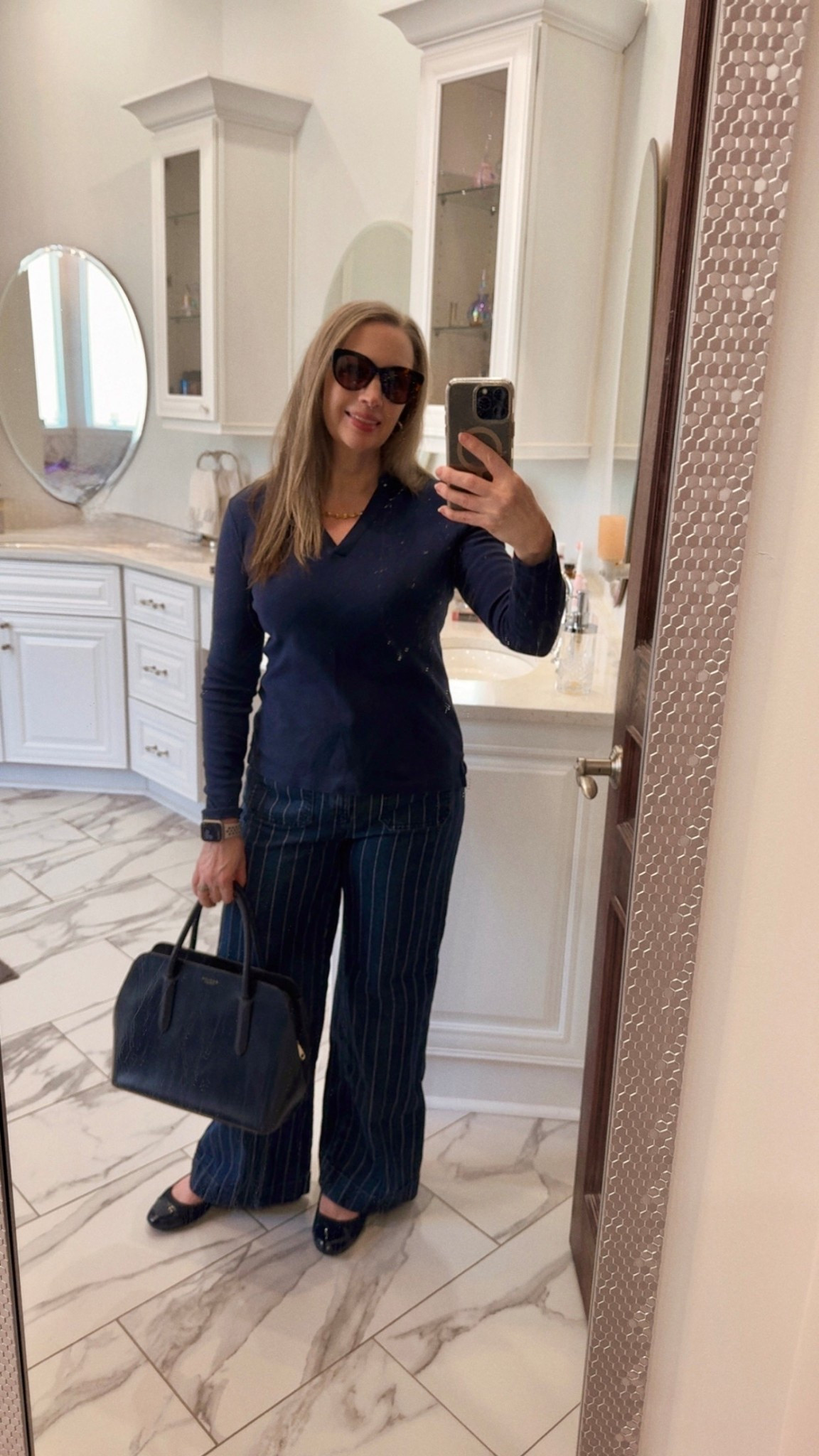 Today, I’m out running errands wearing my comfortable soft pinstripe wide-leg jeans from LOFT, paired with a relaxed navy blue top. I’ve styled them with patent leather-tipped navy flat shoes and a timeless bag for a polished touch. My Radley of London leather bag, which I’ve had for several years, remains a favorite—spacious and with classic lines that never go out of style. I’ve also tagged the Arlington style, which is a close second and has silver hardware if that’s the look you’re going for. ￼
To complete the look, I’m wearing my tortoise shell glasses, which add a nice finishing touch.

#LTKmomlife #LTKootd #LTKPetite