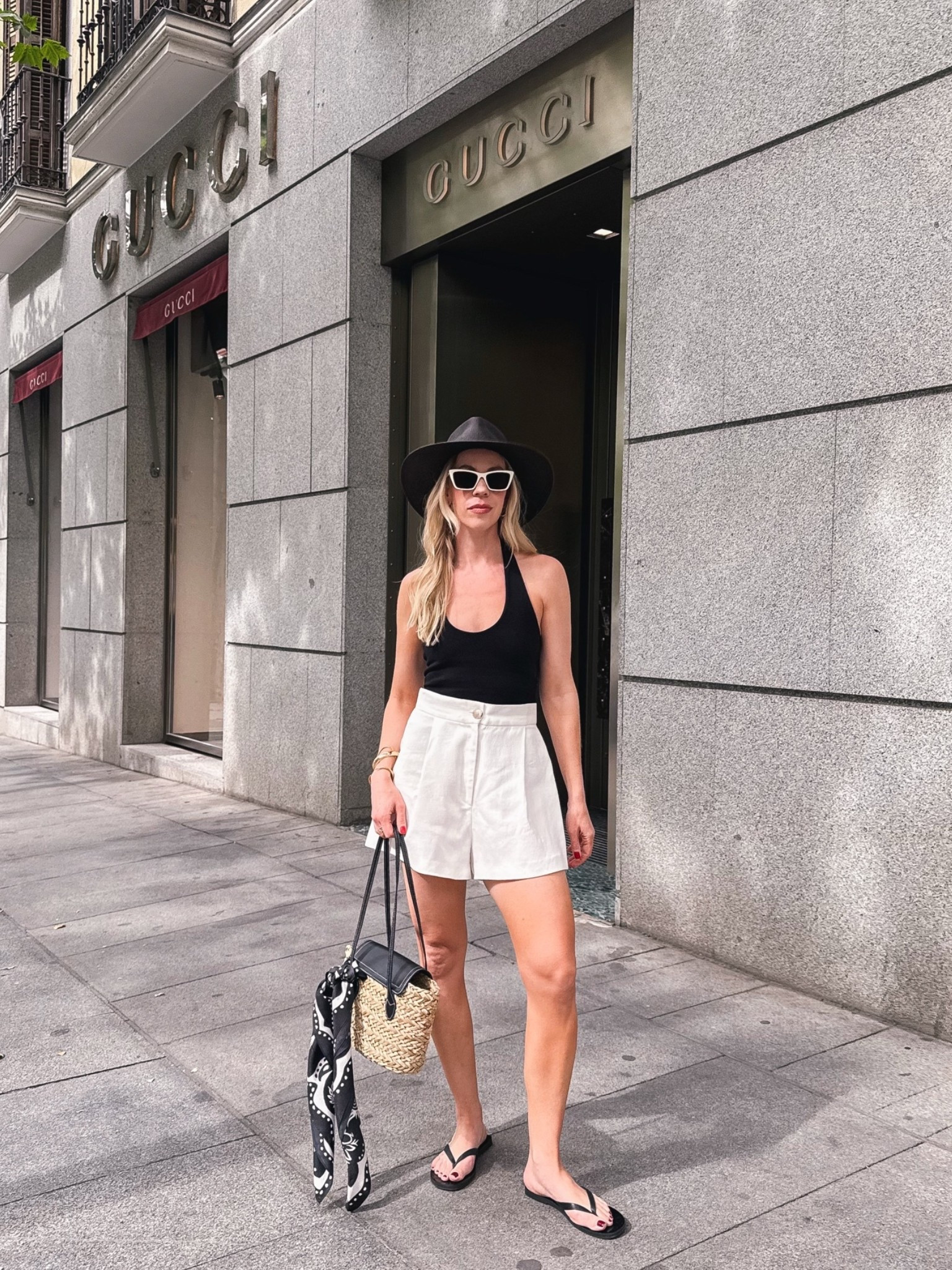 European summer vacation, black and white summer travel outfit, black halter top, white linen shorts, leather thong sandals

#LTKTravel #LTKOver40 #LTKSeasonal