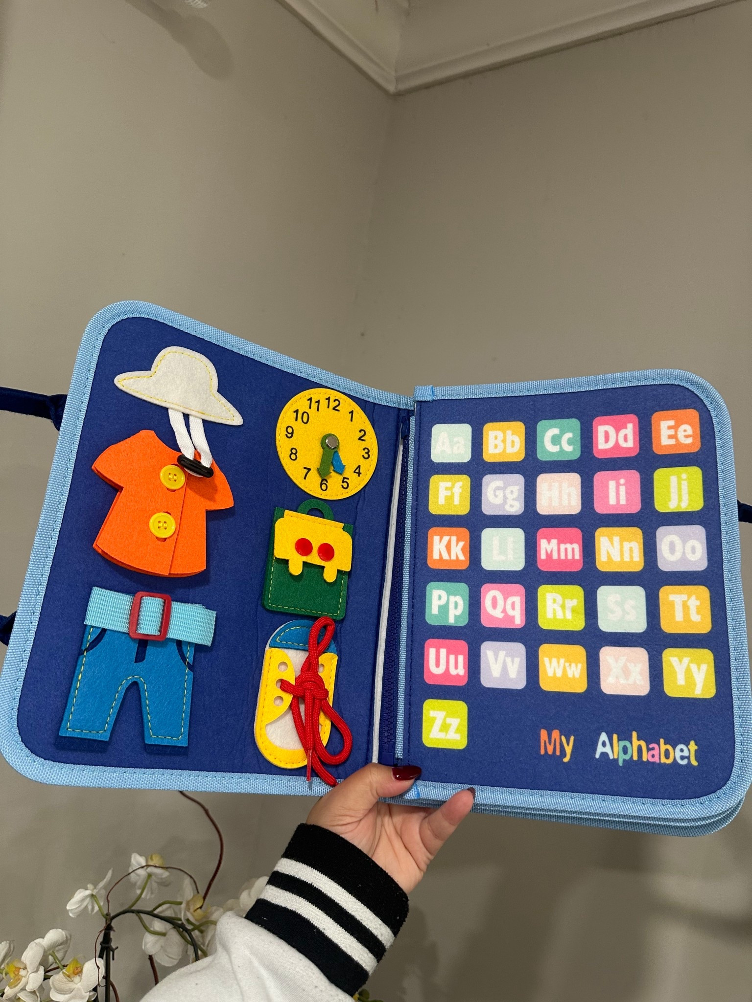 A quiet book packed with learning! From alphabet matching to zipping, buttoning, and tying, this interactive activity book helps build independence and fine motor skills while keeping kids engaged.