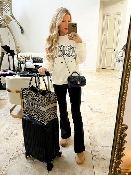 Travel outfit. Airport outfit. Road trip outfit. Jackson hole. Sweatshirt. Flare leggings. Uggs. Luggage 

#LTKsalealert #LTKtravel