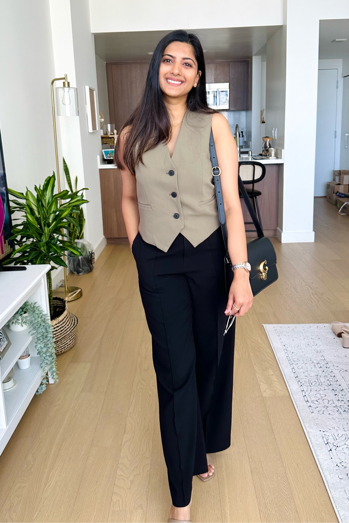 Modern Elegance: Effortless Workwear Chic

Step into the work week with confidence in this polished and modern ensemble. This image captures the essence of professional elegance with a sleeveless taupe waistcoat paired effortlessly with classic black trousers. Accessorized with a sophisticated black handbag and a subtle hint of silver jewelry, it's the perfect inspiration for a work-ready wardrobe that doesn't compromise on style or comfort. The minimalist interior decor serves as a calm backdrop, reflecting a neat, organized lifestyle.
Hashtags: #WorkwearStyle #ProfessionalChic #ModernElegance #FashionForward #OfficeOutfit #MinimalistStyle #SleevelessWaistcoat #ClassyAndChic #OutfitOfTheDay #StyleInspiration

#LTKworkwear #LTKstyletip