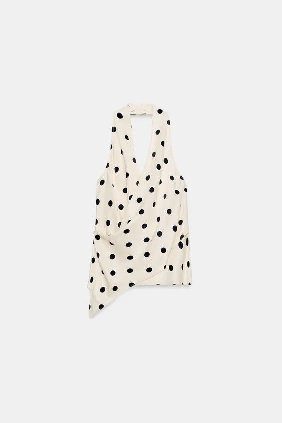 Top made from satin fabric. Halter neck and crossover V-neck. Open back. Asymmetric hem. Side but... | Zara UK