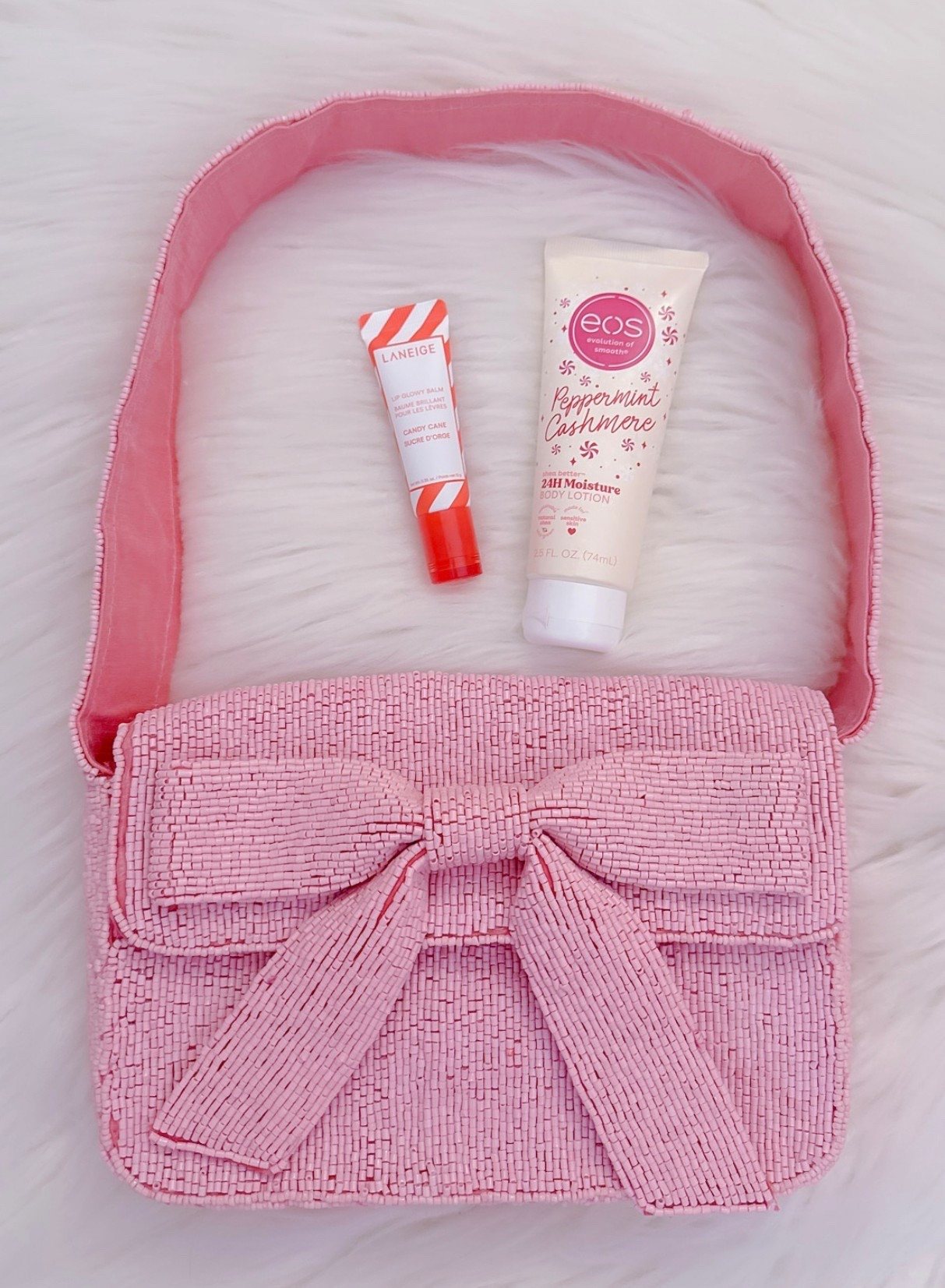What’s in my purse .. Christmas/Winter edition - all are great gift ideas! 

💋Laneige Candy Cane Glowy Lip Balm - as amazing as their sleeping mask! Speaking of .. there’s an on Sale Gift Set of the duo! 
🧴eos Peppermint Cashmere lotion - fighting dry season one minty vanilla shea butter squeeze at a time! 
👛Carrying it all in my pink bow beaded purse! She’s gorgeous & on sale & can be used all year! She’s also on Sale & comes in Red & Silver!

Pink Christmas. Winter Beauty. Stocking Stuffers. 

#LTKHoliday #LTKBeauty #LTKGiftGuide