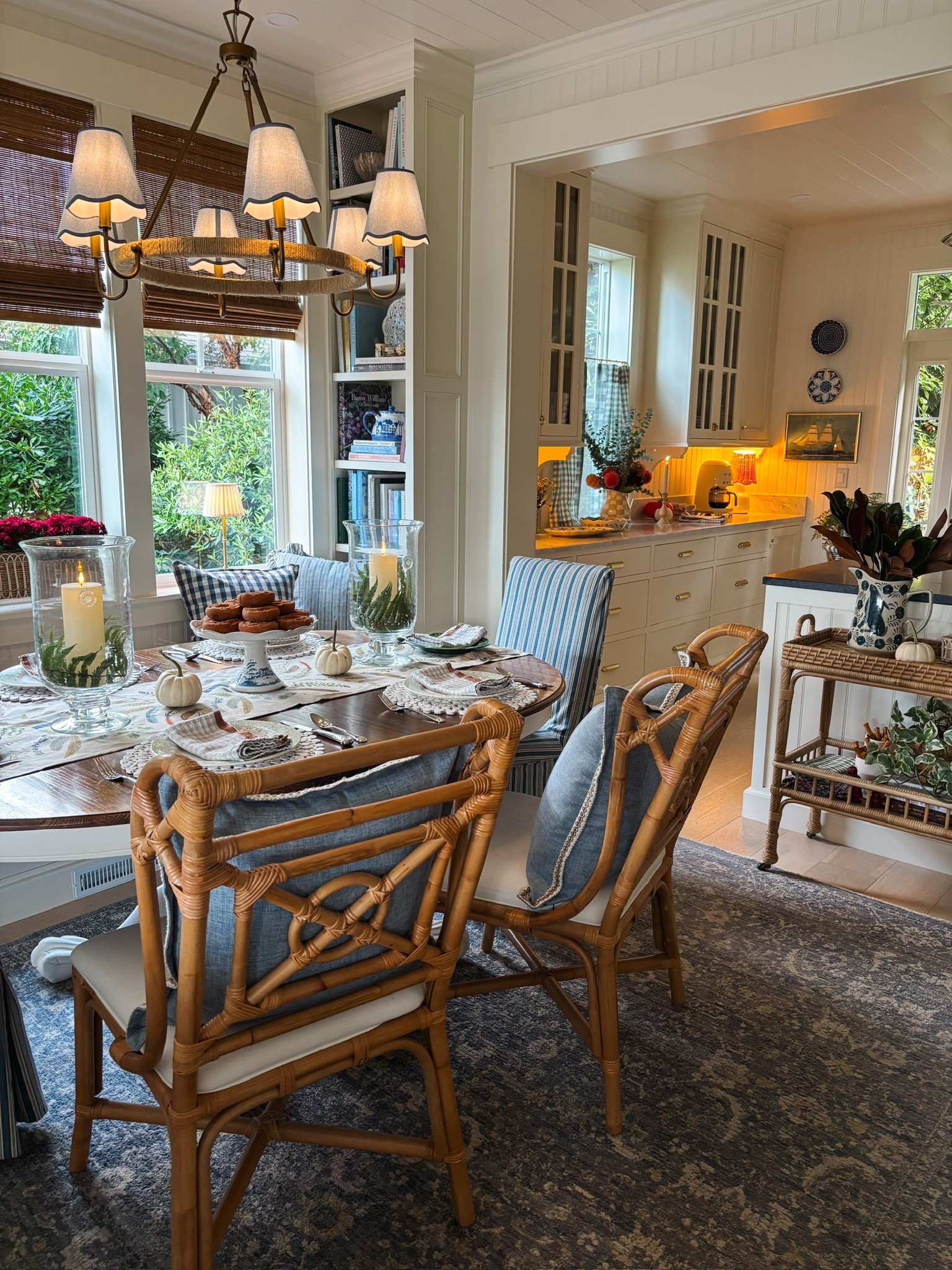 Dining room fall tablescape - bamboo shades, chandelier, rattan cart