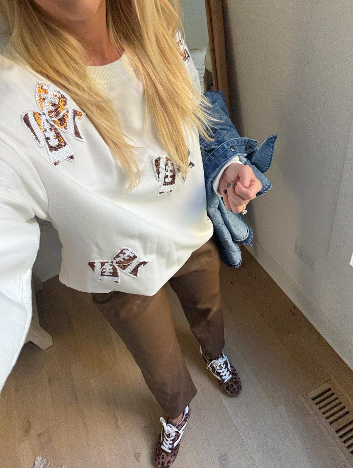 Football outfit for my son's game but great for NFL and college games too. Would be cute for the Super Bowl. I sized up to a L in the top, could have done a medium. I'm wearing a medium in the faux leather pants in the ankle length. I'm 5'4. These pants have a drawstring weight - so comfortable! They are lined too so they feel nice. 

#LTKFindsUnder50