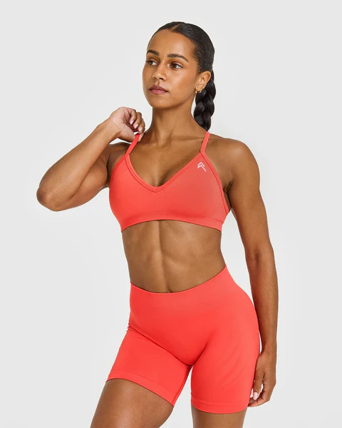 EnhanceLift™ Seamless Strappy Sports Bra with White Logo 
 Charged Coral | Oner Active (UK / US)