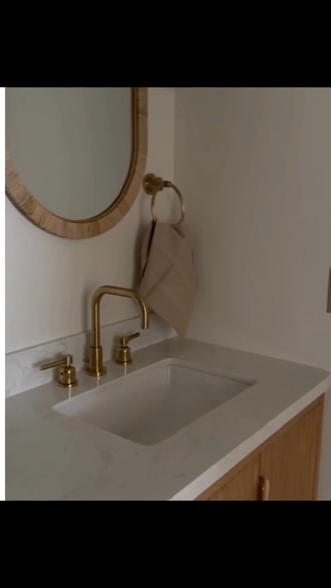 Double vanity with a wood cabinet, brass fixtures, oval mirrors, and a tiled shower with a glass enclosure. For this bathroom, we used an extra-thick grout line and a creamy brown grout color to highlight the tile and tie in with the tones of the wood vanity. Grout color, spacing, and thickness can have a big impact on the overall look of a tiled space. Linking exact and similar pieces here.

#LTKActive #LTKSaleAlert #LTKHome