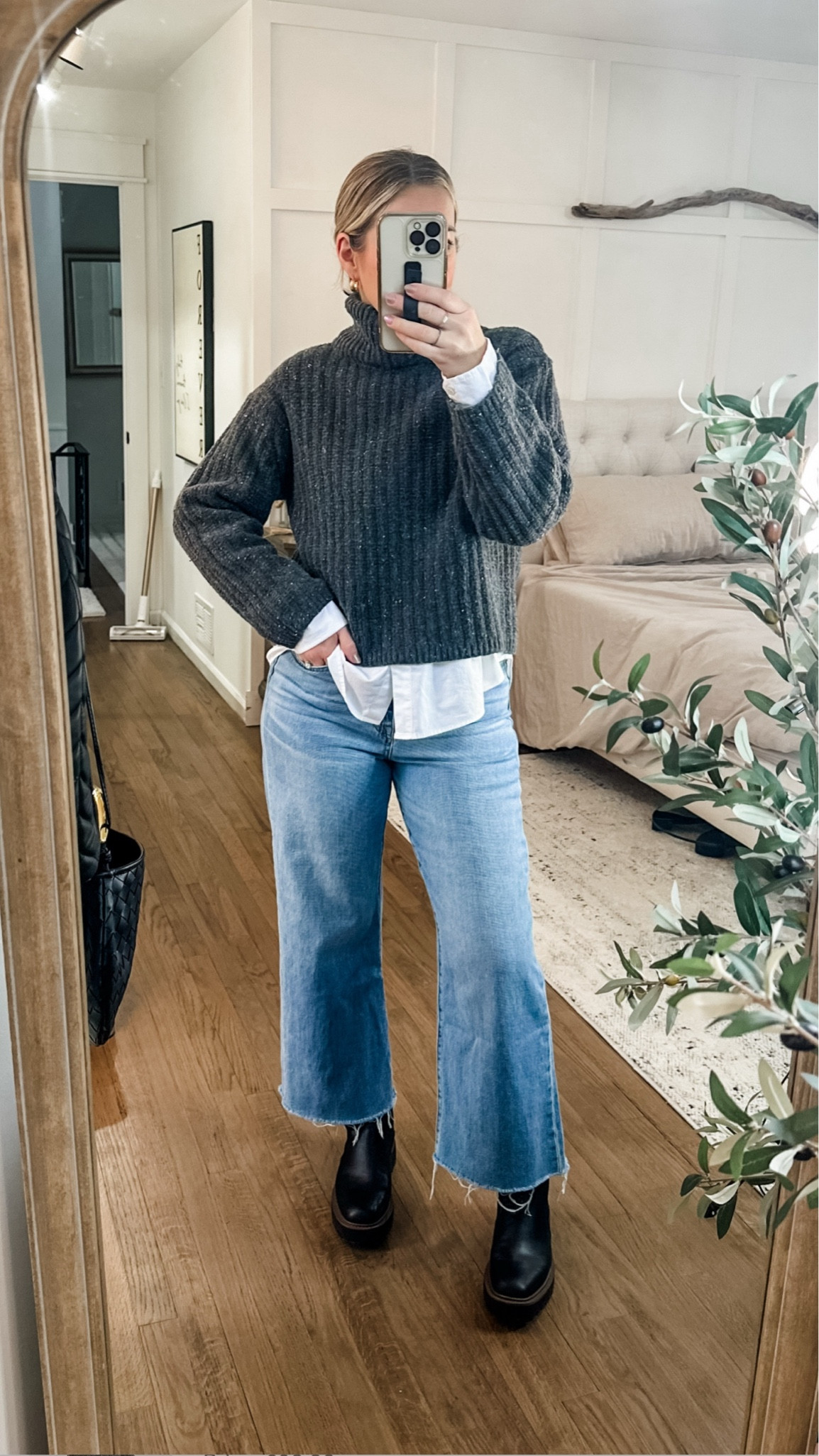 What I wore to work as a teacher in the snow. Loving these cropped wide leg jeans bc the hem stays dry and my weatherproof laguna boots were perfect for the wet snow and sleet. Layer a chunky turtleneck over a white button and pull the hair back in a slick messy bun for a more polished look. Add chunky gold hoops to dress it up and throw on a black overcoat! Medium sweater and button down, tts jeans  

#LTKFindsUnder100 #LTKStyleTip #LTKMidsize