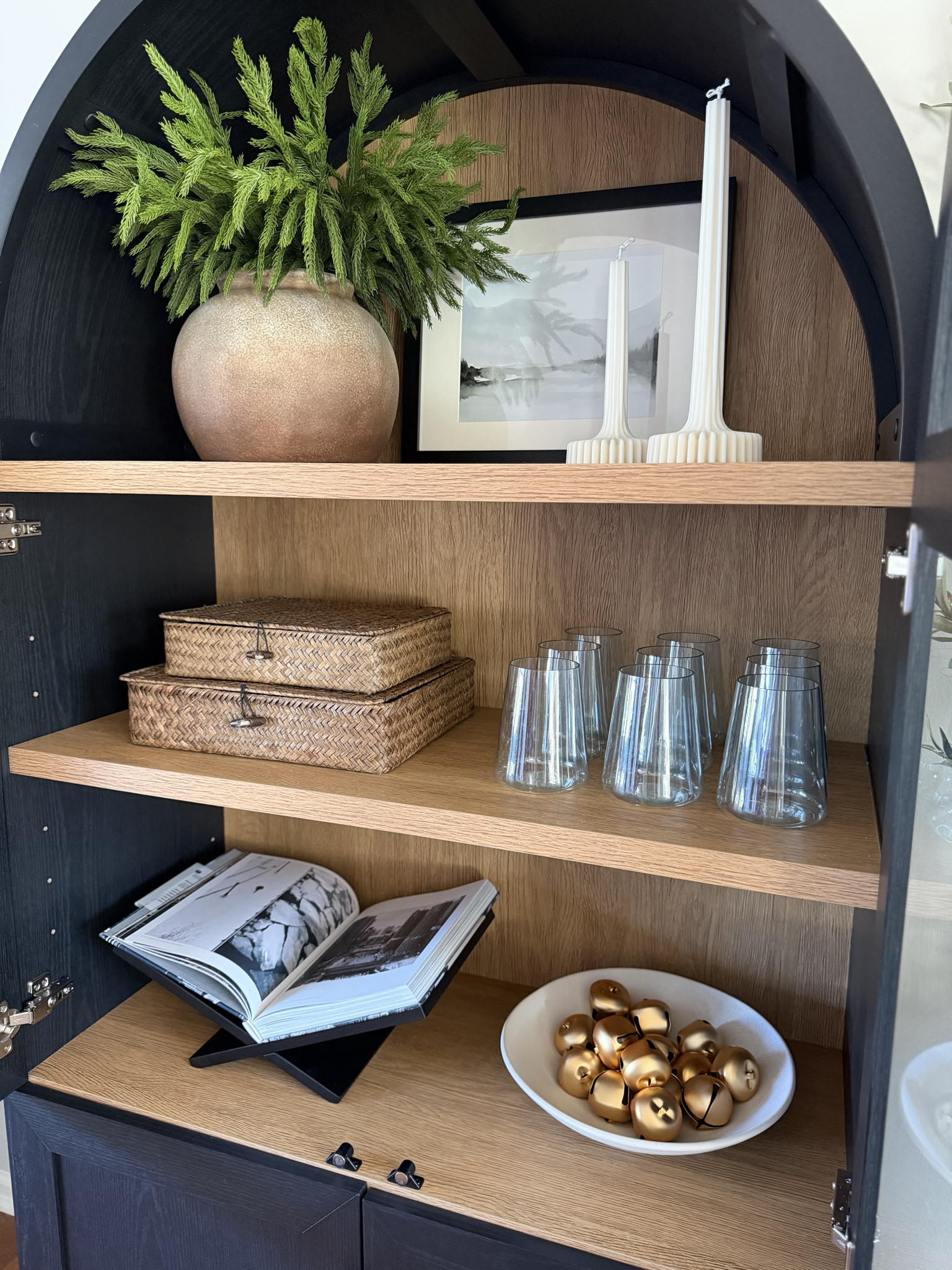 How I styled my arched cabinet this season! I got this new book stand and I love being able to display beautiful pictures from my books! This one showcases some amazing shots around the city of Chicago.

#LTKHome #LTKHoliday #LTKStyleTip