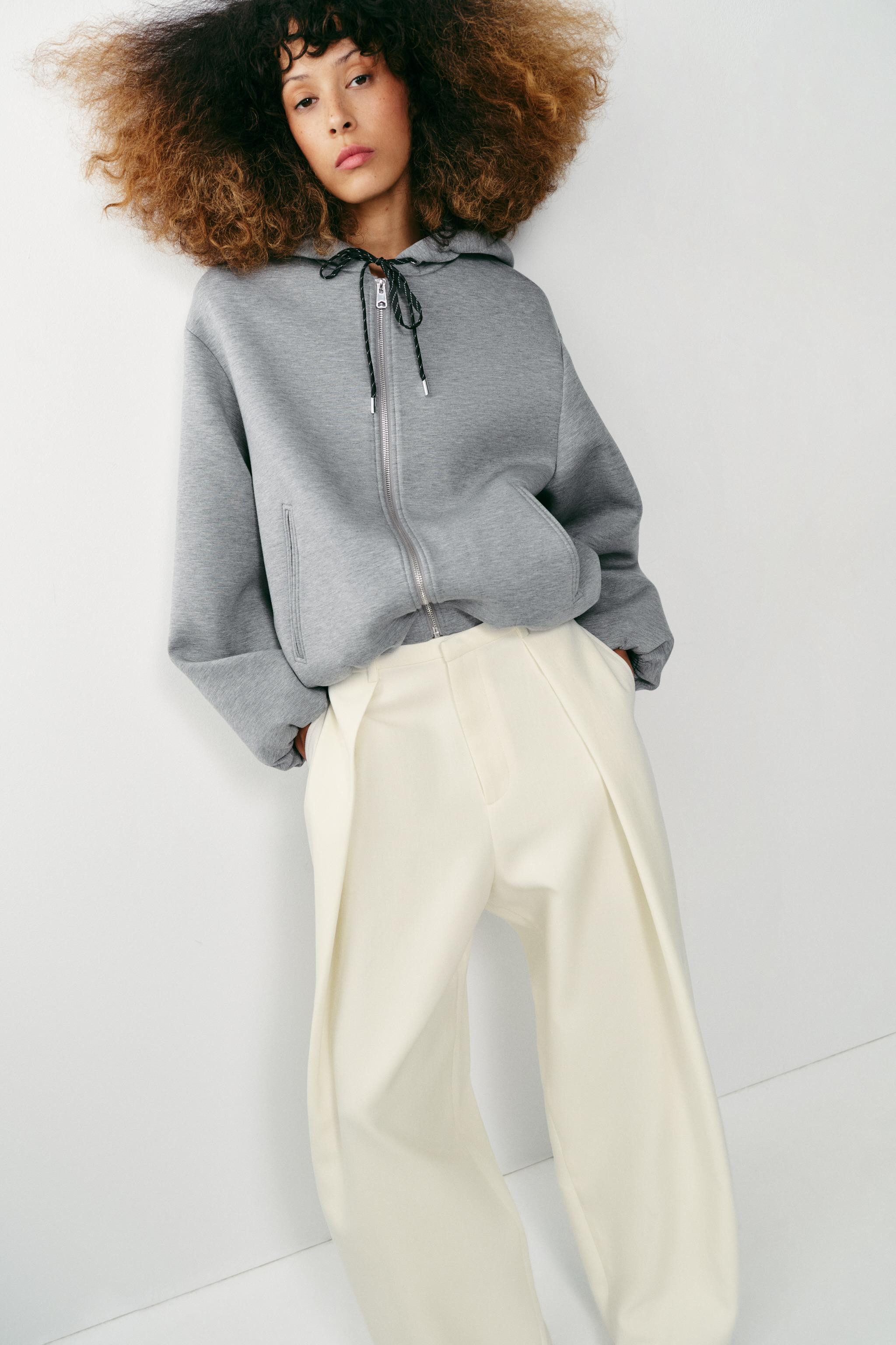 Sweatshirt with adjustable drawstring hoodie and long sleeves. Front double welt pockets. Puffed ... | Zara US
