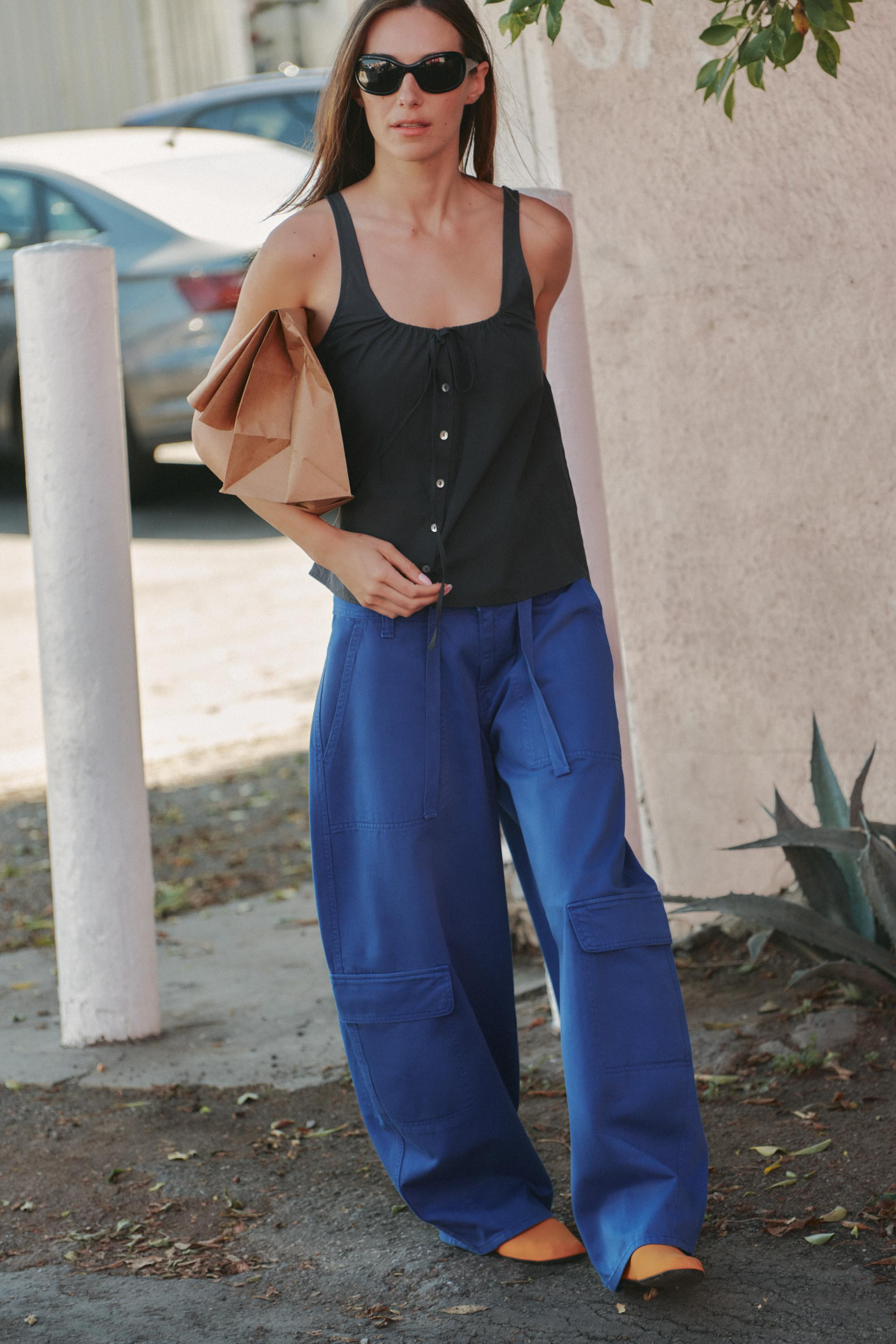 Mid-waist trousers with belt loops and adjustable ties. Patch pockets on the front, back and legs... | Zara UK