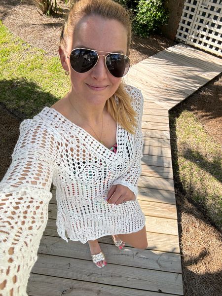 White crochet cover-up currently on sale. Fits true to size

Tropical print black one piece swimsuit underneath that’s got a great fit.

Amazon sunglasses and gold metallic slide sandals to accessorize 

Summer beach outfit staple, pool day look,  vacation outfit 

#LTKSeasonal #LTKtravel