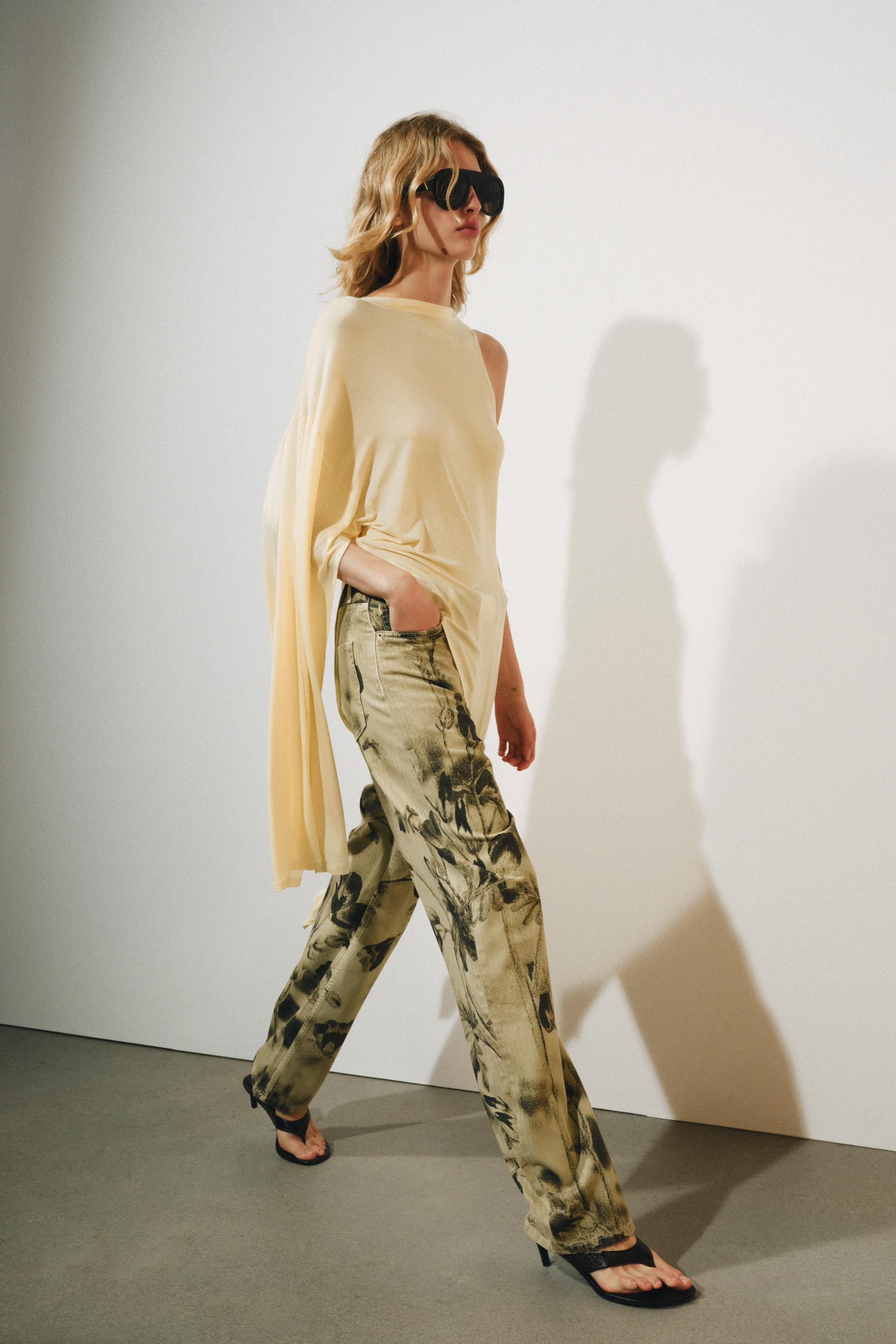 Top made from a lyocell blend yarn. Round neckline with asymmetric sleeves. Straight hem. | Zara US