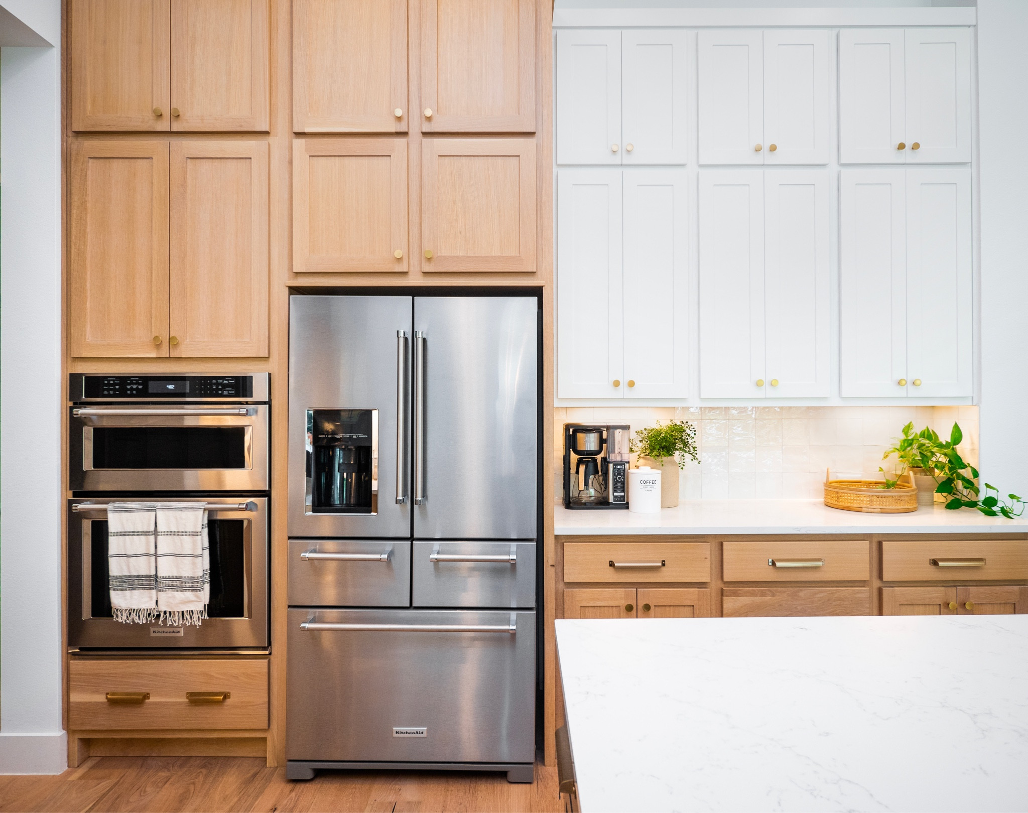 White oak continues to grow in popularity among home builders and home owners looking to renovate, but it can be quite pricey. 😅 Mixing cabinet colors in your kitchen can give you the best of both worlds: savings & style! White oak was used in about half of this kitchen cabinet design. The rest is a material similar to MDF, just painted white. 😜 

#LTKhome
