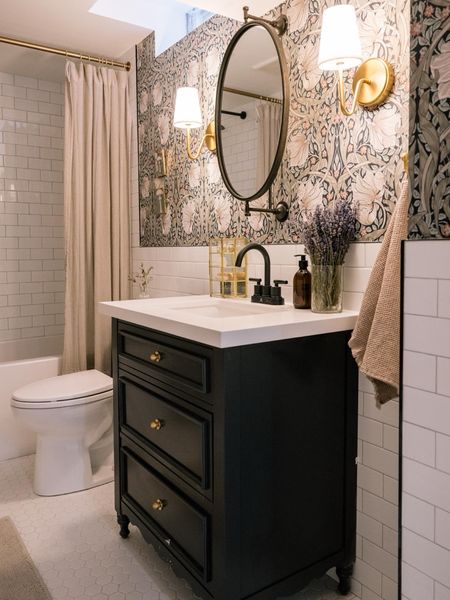 Our basement bathroom is moody and dramatic in the best way. This striking wallpaper really sets the tone and I love that swivel mirror!

#LTKhome