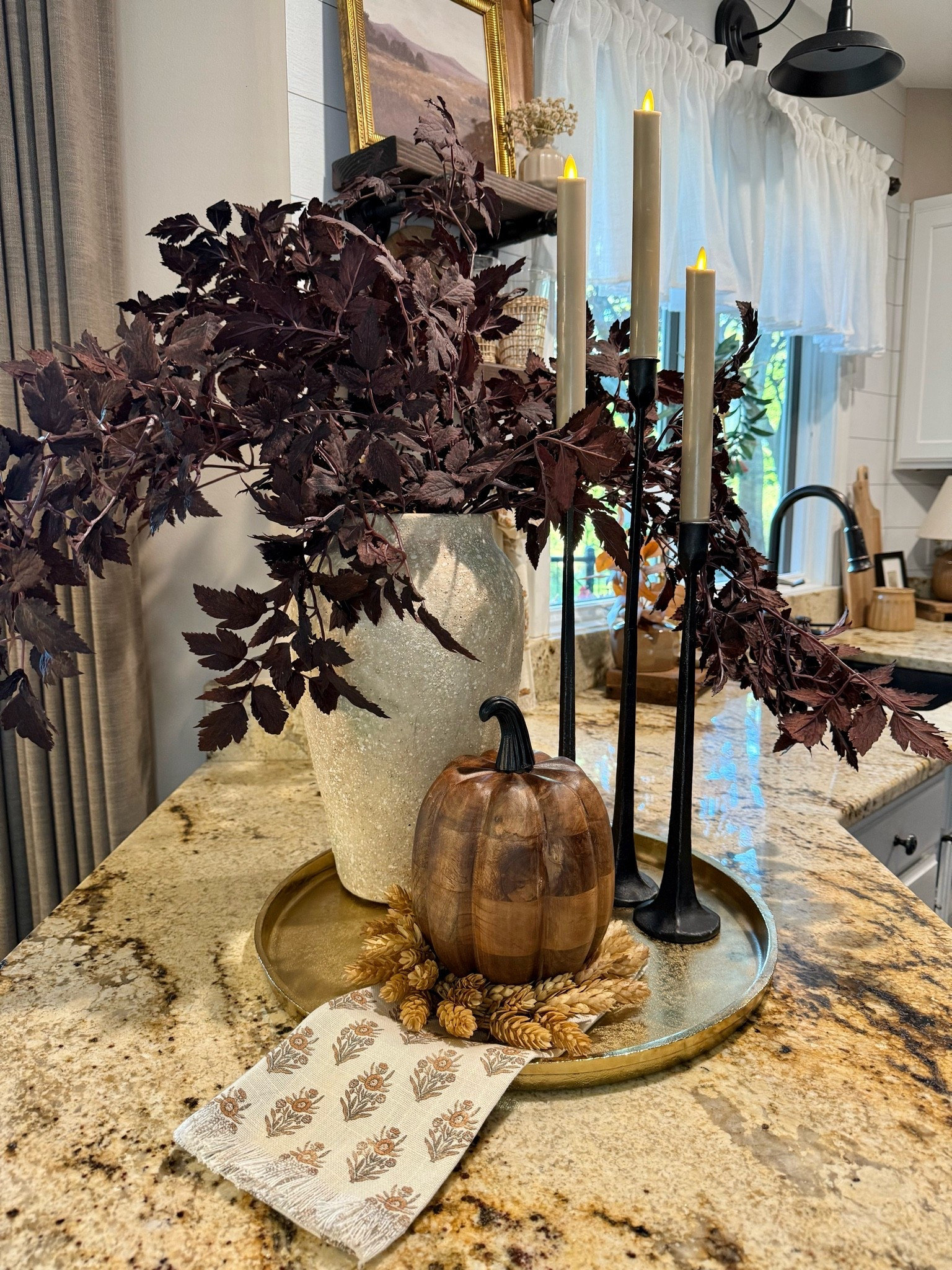 Warm & Moody Fall Styling for the Kitchen Countertop
Follow @farmtotablecreations on Instagram for more seasonal home inspiration 🤎

This cozy fall vignette adds the perfect touch of seasonal charm to the kitchen. I styled a neutral round tray with deep plum stems for contrast, sleek black candlesticks with flameless taper candles for ambiance, and a rich wood-look pumpkin for that layered organic warmth. I also love tucking in a hops  candle ring  and folded autumn napkin for a curated, collected feel.



#fallkitchendecor #fallstyling #amazonhomefinds #targethome #walmarthome #falltraydecor #fallpumpkindecor #candlestickstyling #kitchencounterdecor #flamelesscandles #moodyfall #amazonstems #ltkfall #kitchendecorideas

#LTKSeasonal #LTKSaleAlert #LTKHome