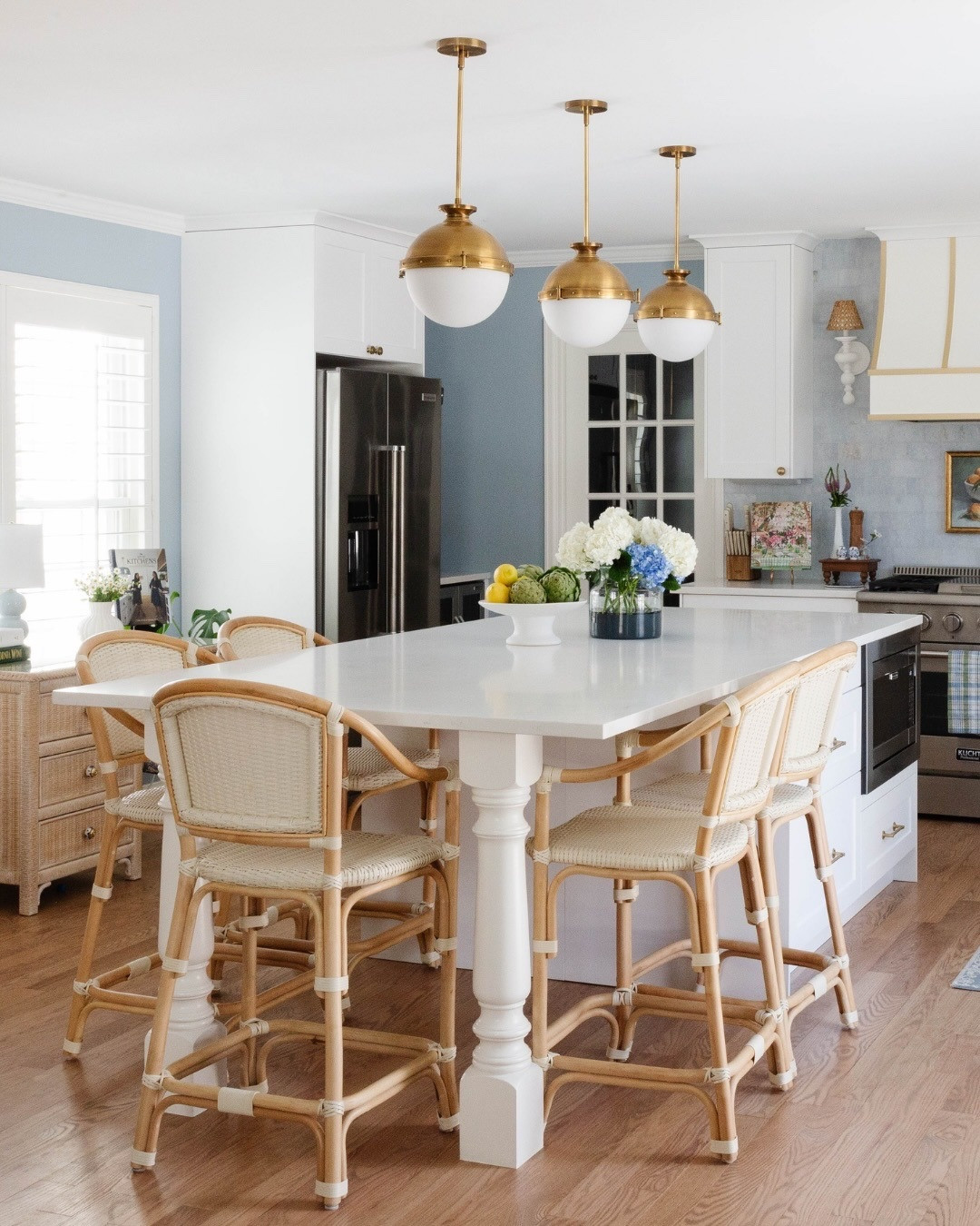 This Saltbox kitchen in Columbine Valley was redesigned to solve what the original layout couldn’t - function, flow, and a clear sense of purpose.

We reworked the footprint to introduce a proper island, created a defined range wall as a focal point, and layered in traditional materials. Blue marble, warm brass, and turned-leg detailing to bring structure and character back into the space. The result is a kitchen that feels organized, intentional, and rooted in classic design, while supporting the way the family lives today.

One of the details that ties it all together is the paint color. As recently shared with @marthastewart, Peggy calls @farrowandball Parma Gray her go-to “color-as-a-neutral” for classic kitchens. Its soft blue tone with just a whisper of gray feels calm and timeless, complementing warm woods, brass accents, and crisp white cabinetry without overpowering the space.  Thank you, @hmbien for including us in this story!

For those considering a renovation, new build, or larger-scale furnishing project, we always welcome the opportunity to connect. We are currently accepting inquiries for projects beginning in Q4 2026 and Q1 2027.

Design // @peggyhaddadinteriors
Photography // @karadeyoung 

For sources and similar pieces from this space, comment SHOP and we’ll send the LTK details your way. https://liketk.it/5jzX3

#peggyhaddadinteriors #GrandmillennialStyle #TraditionalInteriors #LayeredInteriors #projectgrandmillennial