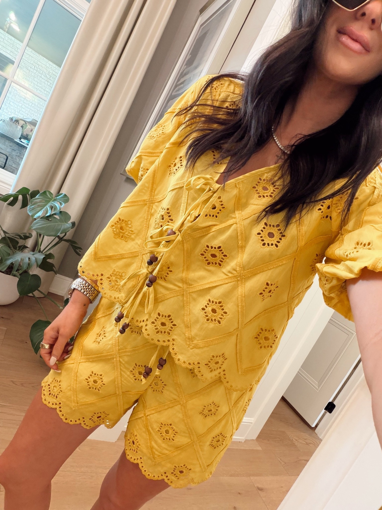 Matching shorts are pictured in white directly next to yellow top!