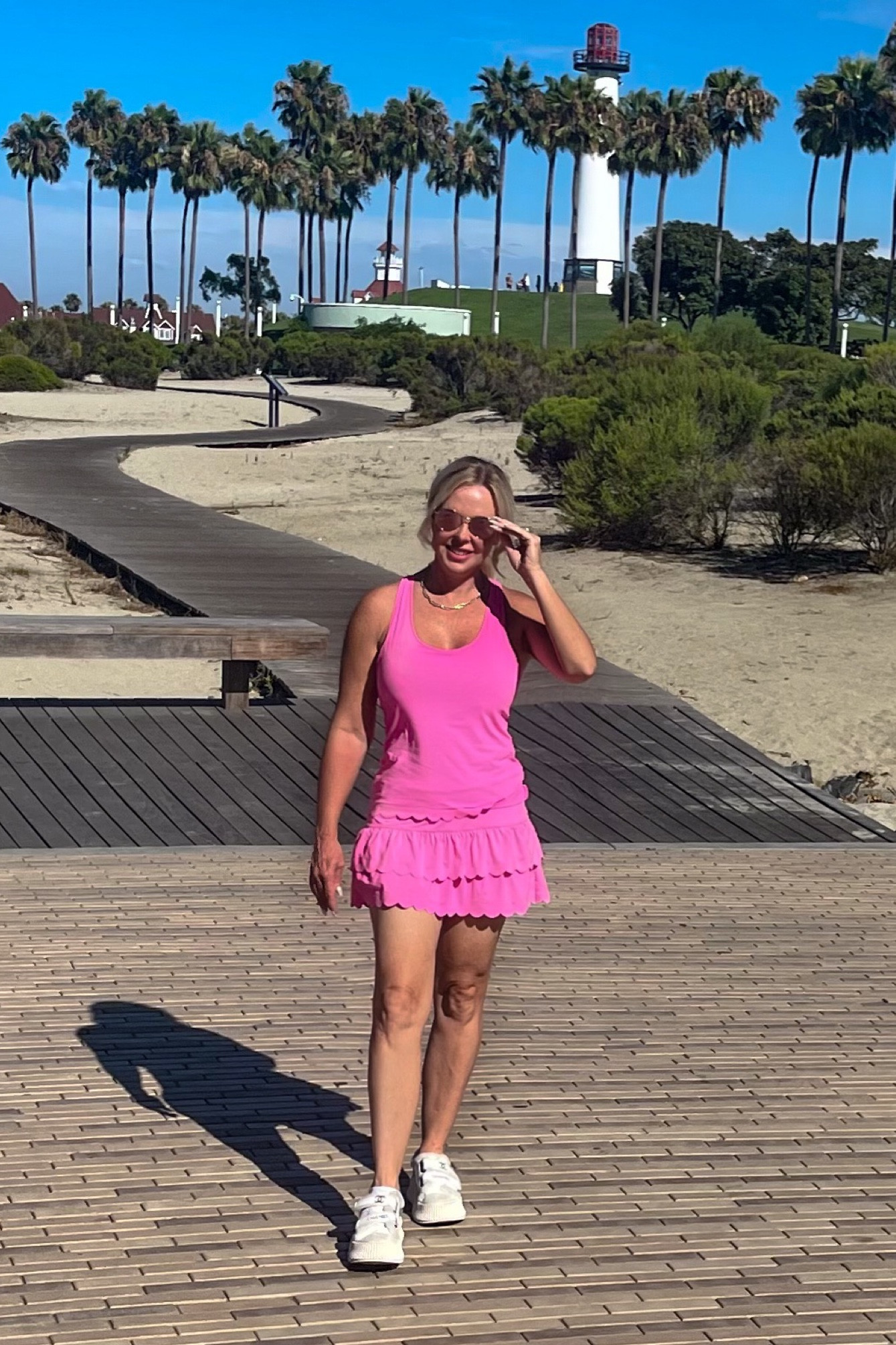 This look gives me Barbie vibes! Been spending time in beautiful sunny Long Beach this week. Lots of site seeing! This  skort and top is great for active vacations with lots of walking, etc. The tank top and bottom have scalloped hem, and the material has UPF 50+ sun protection. There's also a pocket in the undershort for your phone, etc. Comes in other colors too - white, navy, and black. 

#LTKtravel #LTKFitness #LTKFind