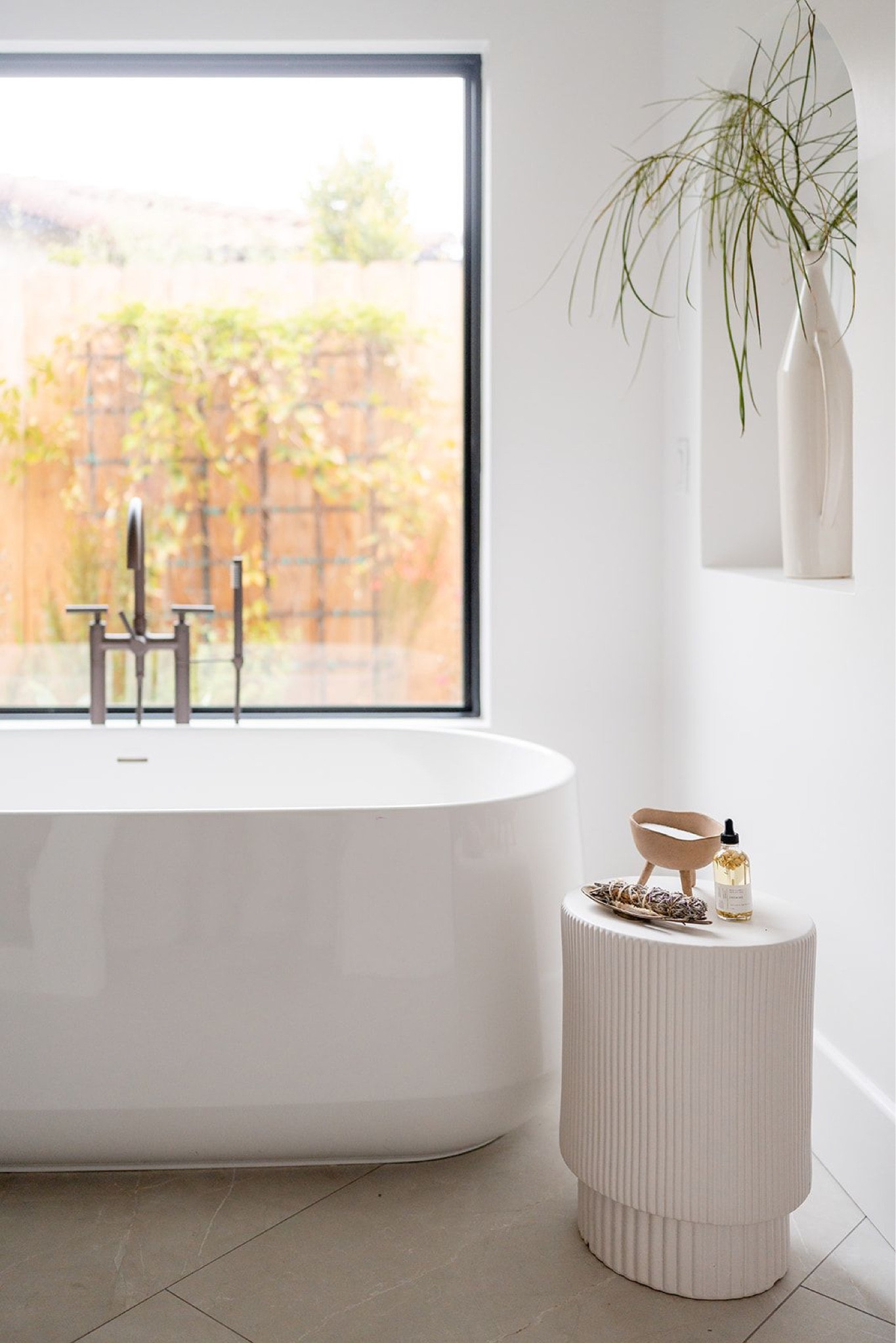 Spa inspired bathroom 

Freestanding tub, floor mounted tub filler, west elm fluted side table, cb2 round mirror, parachute bath towel, vases, and stems.

Home decor, bathroom interior, home finds, soaking tub, bathroom styling, interior design, bathroom design, fluted decor, bathroom accessories, accent table, spa bathroom, white vase, fluted table, bathroom decor. 

#LTKstyletip #LTKhome #LTKFind