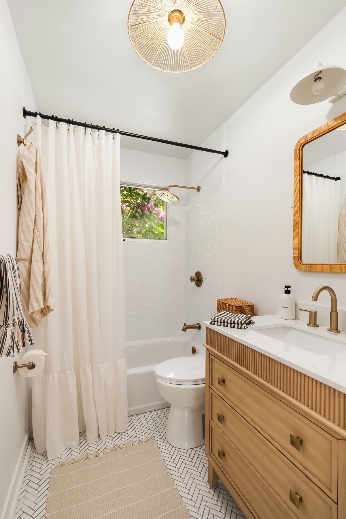 We first renovated this bathroom in 2017 when we bought this house. Over the summer (7 years later!), we made few new small updates that had a BIG impact. One of my favorites: shifting the shower curtain higher, and buying an extra long one. Simple and such a game changer. 