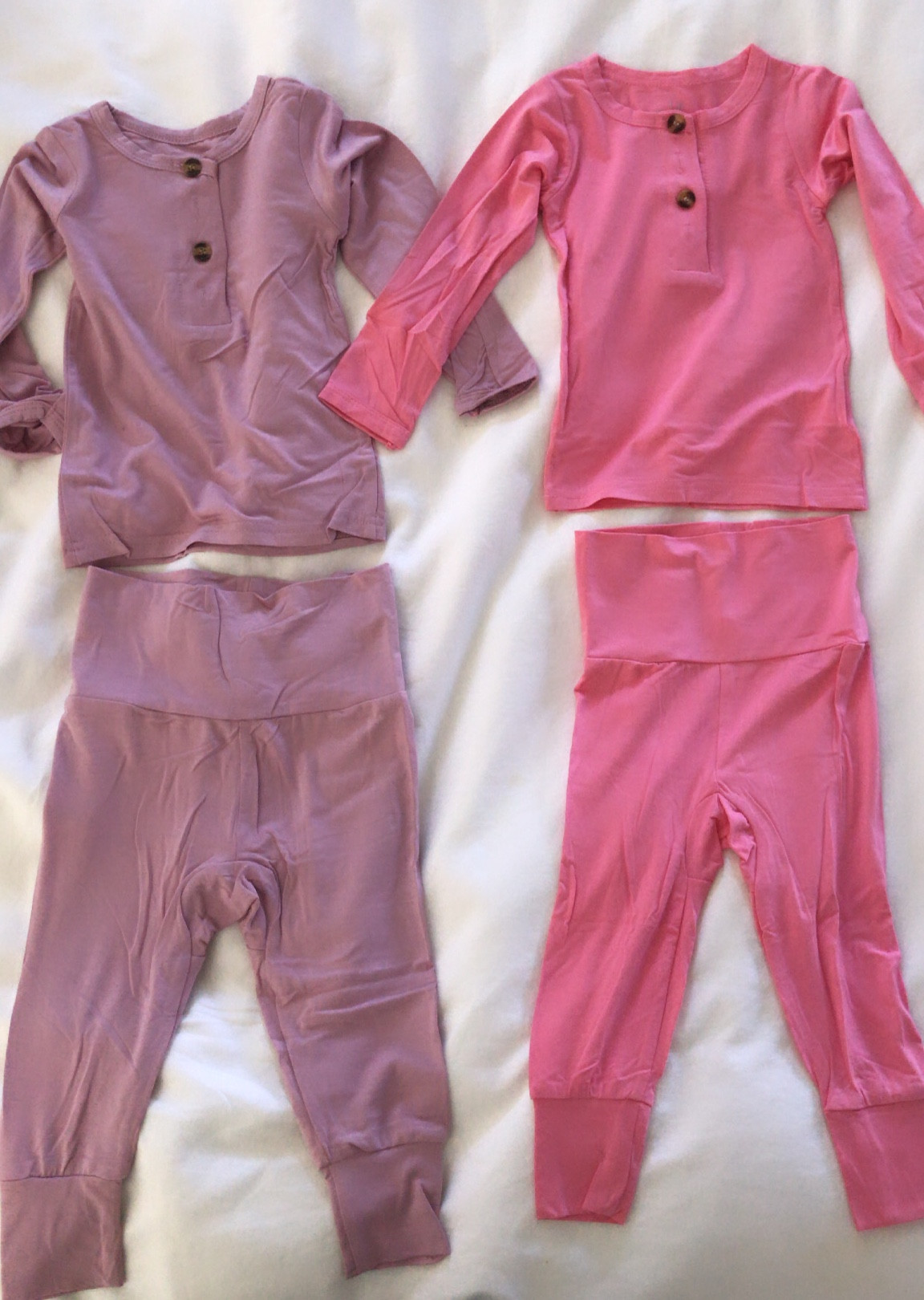 My favorite set for Elora bc they are stretchy so she can wear them forever!! I love putting the pants over bodysuits. The top has FOUR functioning buttons - only two were buttoned in pic. It makes the cutest outfit together or mismatching. These colors from left to right are Roseberry & Cotton Candy. There are toooooons of other colors too! #loungeset #babyloungeset 

#LTKbaby #LTKunder50 #LTKkids