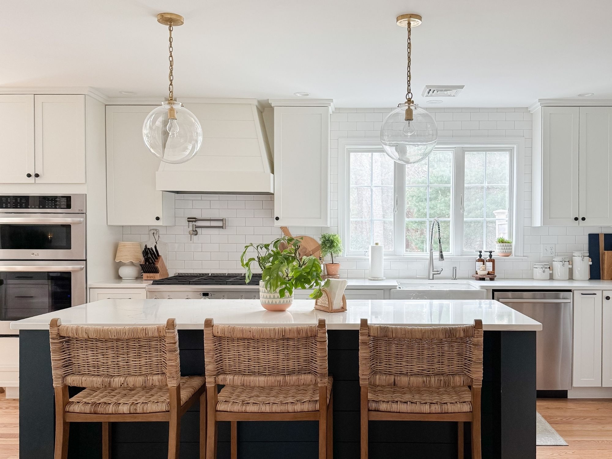 A cape cod coastal kitchen layered with warm woven textures, soft brass lighting, and timeless white cabinetry that keeps the space feeling light, classic, and inviting. These details create a relaxed coastal kitchen that feels elevated but still lived in. 
Cape cod kitchen, coastal kitchen decor, coastal kitchen island, woven counter stools, brass pendant lights, neutral kitchen styling, amazon finds, coastal neutral home, sherri calnan home

#LTKHome