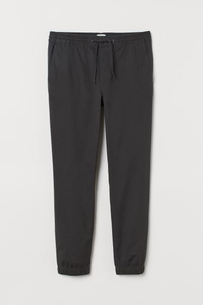 Relaxed-fit joggers in stretch cotton twill with a lightly brushed finish. Elasticized drawstring... | H&M (US + CA)