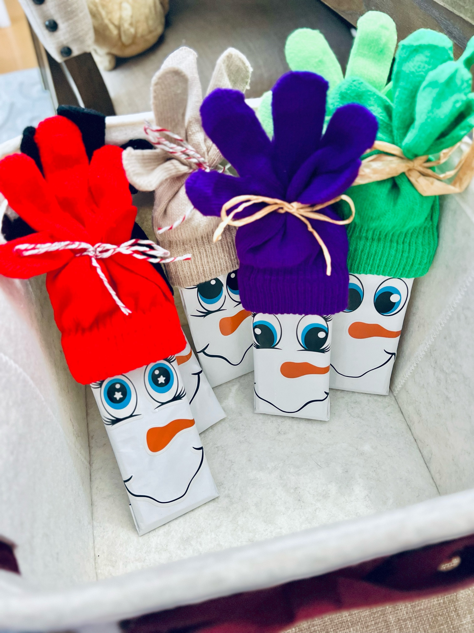 I cannot get over the cuteness in these snowman chocolates I’m making for my children’s classmates! So simple and beyond adorable AND practical!!  🙌🏼

I wrapped the candy bar with the foil (white side out) and taped. Then I take one of the gloves and fold it so it fits inside the other and I place it over the candy bar. Grab some Christmas string and tie the fingers of the gloves together. I added snowman face stickers to the white part of the candy bar and voila 🤗

#LTKkids #LTKGiftGuide #LTKparties