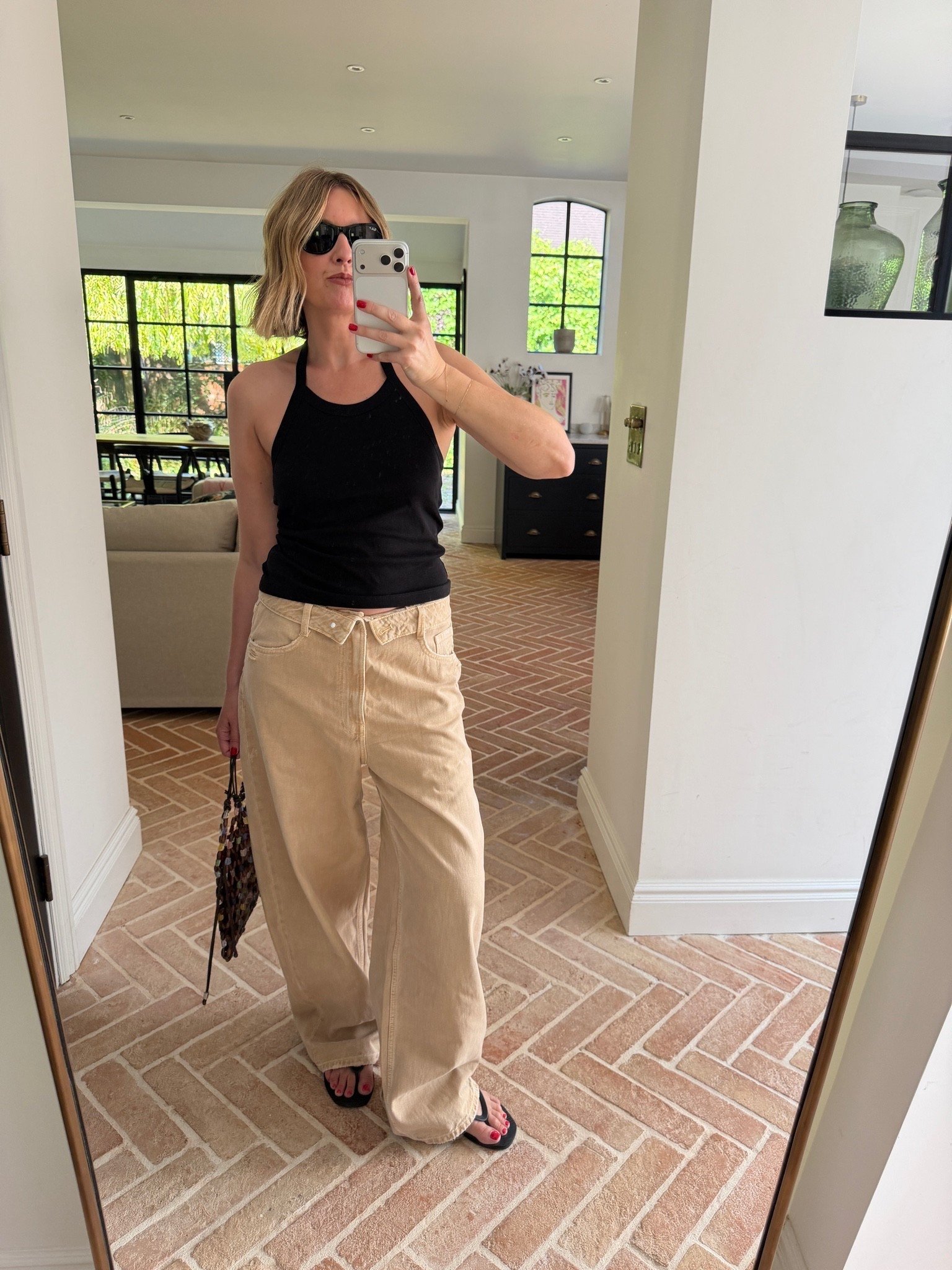 black halter top, black tank top, halter neck top, khaki wide leg pants, tan wide leg trousers, khaki denim, oversized trousers, beaded bucket bag, woven beaded bag, black flip flops, thong sandals, black sunglasses, neutral tonal outfit, elevated basics, quiet luxury, effortless summer style, minimalist off duty look, ltkstyletip, ltkseasonal, ltksummer, ltkfindsunder100, outfit inspo, capsule wardrobe essentials

#LTKuk #LTKjeans #LTKdatenight
