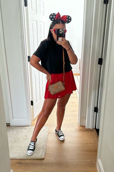 Disney outfit inspiration. Red alo skort wearing size medium. Black crop top from good American wearing size small. Sequins Minnie ears. Converse all star slip on sneakers. Gucci vintage crossbody Mickey disney bag 