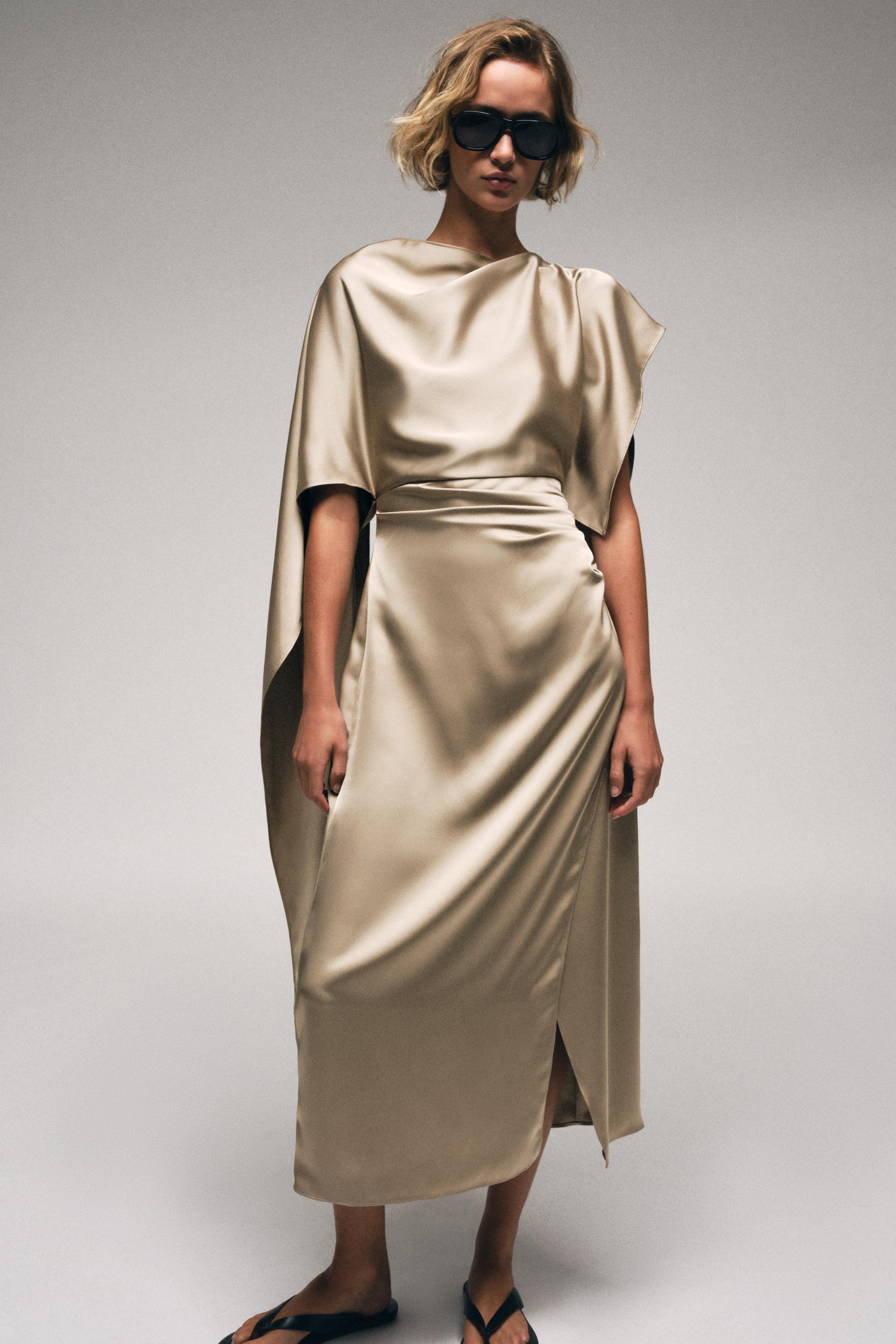 Midi dress with boat neckline and asymmetric cape-style sleeves. Side pleat detail at waist. Fron... | Zara US