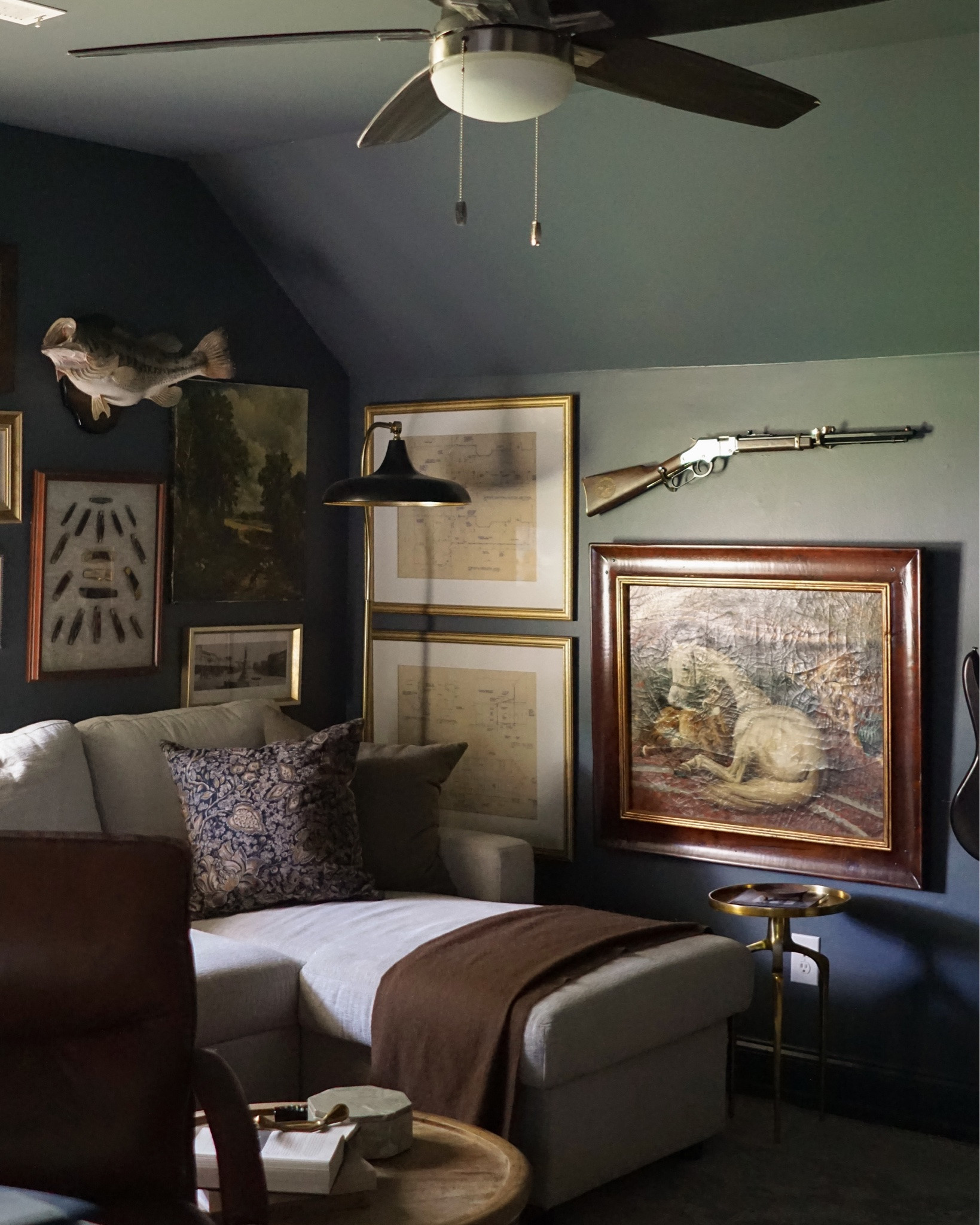 John let me live out my “moody English hunting lodge” dreams in his office and it’s one of everybody’s favorite spaces (especially Piglet 🐶). The walls are full of sentimental and collected pieces that we love, and the moody blue paint color makes it feel so cozy.

Piglet LOVES to lay on the back of the couch and look out the window. He’s also very particular about this cushion — we tried to rotate it out with another one so it didn’t get too worn and he wouldn’t even sit on the other one… so this one is all his 😂

John let me live out my “moody English hunting lodge” dreams in his office and it’s one of everybody’s favorite spaces (especially Piglet 🐶). The walls are full of sentimental and collected pieces that we love, and the moody blue paint color makes it feel so cozy.

I finally found a pair of matching frames for these blue prints at an estate sale. We found these blue prints in the workshop from 1999 when the screened in porch was added and I felt like they were perfect for this gallery wall. I want to get new mats, but the frames are just perfect here!

I found this framed, hand painted reproduction of The Arab Tent by Edwin Henry Landseer at an estate sale last year for $60 and it’s one of those pieces I wish I could have in multiple spaces all at once. The texture on the piece is just stunning, the frame is INCREDIBLE, and I just love anything with animals 🥹