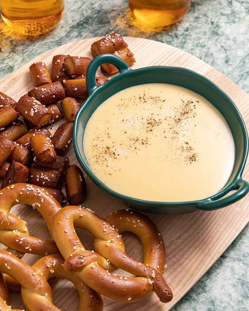 Beer cheese is America’s answer to Fondue: it’s melty, delicious, and makes just about anything taste better. 

Ingredients
* 1/4 cup unsalted butter
* 1/4 cup all purpose flour
* 3/4 tsp garlic powder
* 3/4 tsp onion powder
* 1/2 tsp mustard powder
* 1/4 tsp Worcestershire sauce
* 3/4 cup milk
* 1 cup beer of your choice
* 2 cups grated cheddar
* 1 cup grated gruyere
* Pretzels for serving

Instructions 
* In a medium saucepan, melt the butter over medium-high heat. Add the flour and stir constantly until a wet, sand-like texture forms, 3-5 minutes. Stir in the garlic powder, onion powder, mustard powder, and Worcestershire sauce; cook for another 30 seconds. Add the milk and beer and whisk until smooth. Bring to a simmer and cook until thickened, 30-60 seconds more. 
* Add a third of the cheddar and gruyere cheeses; whisk until melted and fully incorporated, about 1 minute. Repeat with remaining cheese. 
* Serve in a bowl with pretzels on the side for dipping. 

#LTKSeasonal #LTKfoodie
