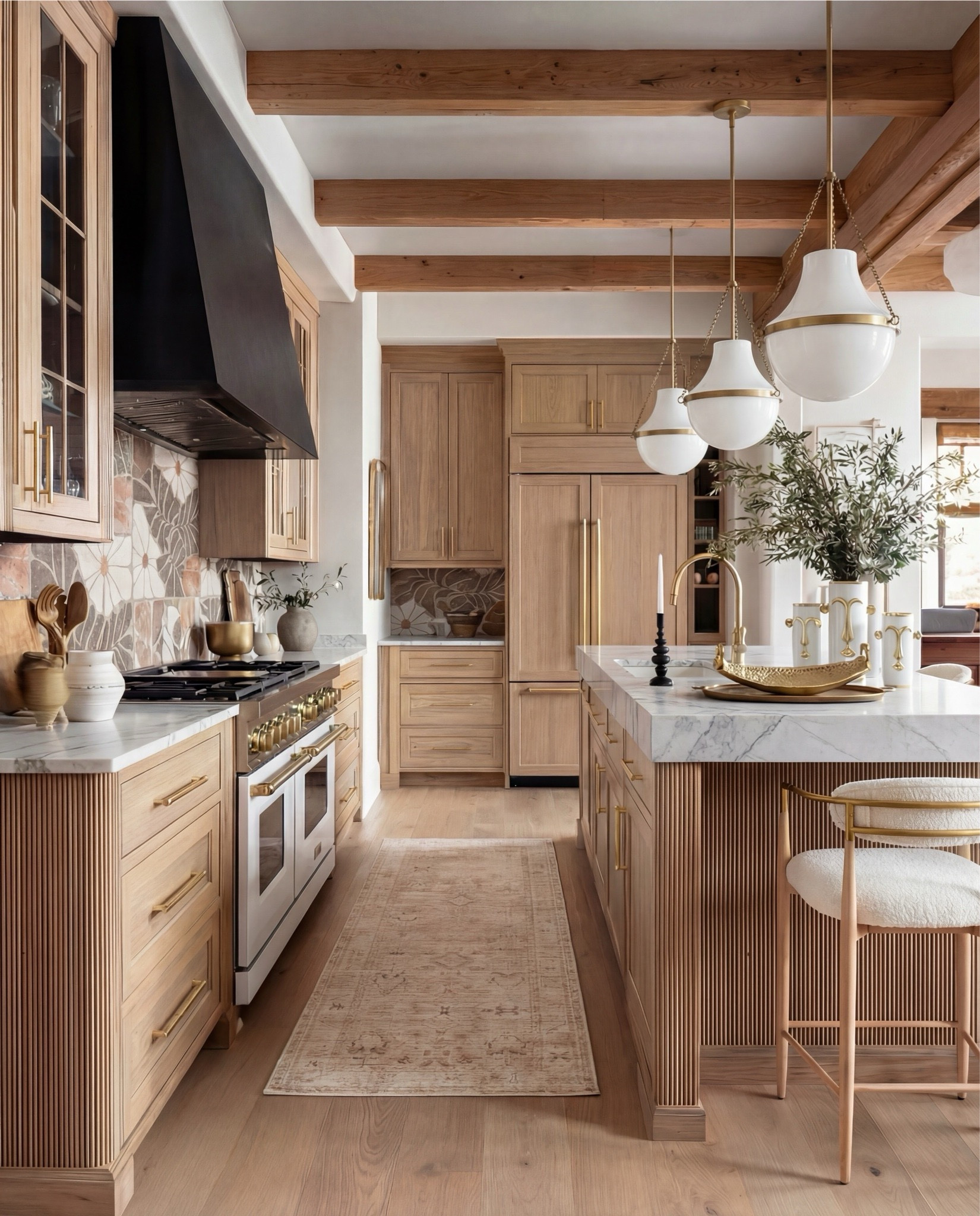 Shop the Look:
• Natural oak cabinetry (with fluted island detail)
• White + brass sculptural pendant lights
• White gas range with brass trim
• Warm floral tile backsplash
• Boucle + brass bar stools
• Marble countertops (soft veining)
• Brass kitchen hardware
• Ceramic vases + stone serveware
• Neutral vintage runner
• Gold tray + candle holders
• Oak beams (warm rustic contrast)

#LTKSaleAlert #LTKHome