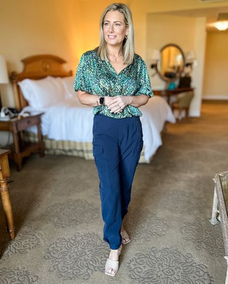 Taking advantage of the golden hour from INSIDE my hotel room-it was so hot in Dallas! Got a lot of questions about this beautiful flowy blouse that is a great transition piece from summer to fall. It’s a bit oversized-wearing mine in a small. It also comes in a blue/pink combo  Paired it with one of my go to travel pants that are so forgiving. They fit me when I was 10 pounds heavier and fit great now. Wearing a size 4. Shoes are a new find and I like the slightly lower heel! #summertofall #blouse #cargopants #shopavara #easyoutfit #traveloutfit #fashionover40 #fashionover50 

#LTKFind #LTKtravel #LTKworkwear