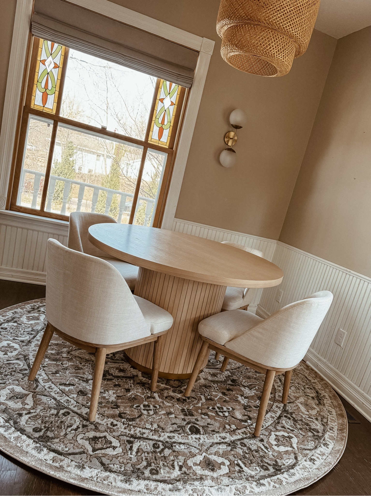 boho dining space, gold wall sconce, round area rug, round fluted dining table, upholstered dining chairs, natural wood dining table & chairs

#LTKhome