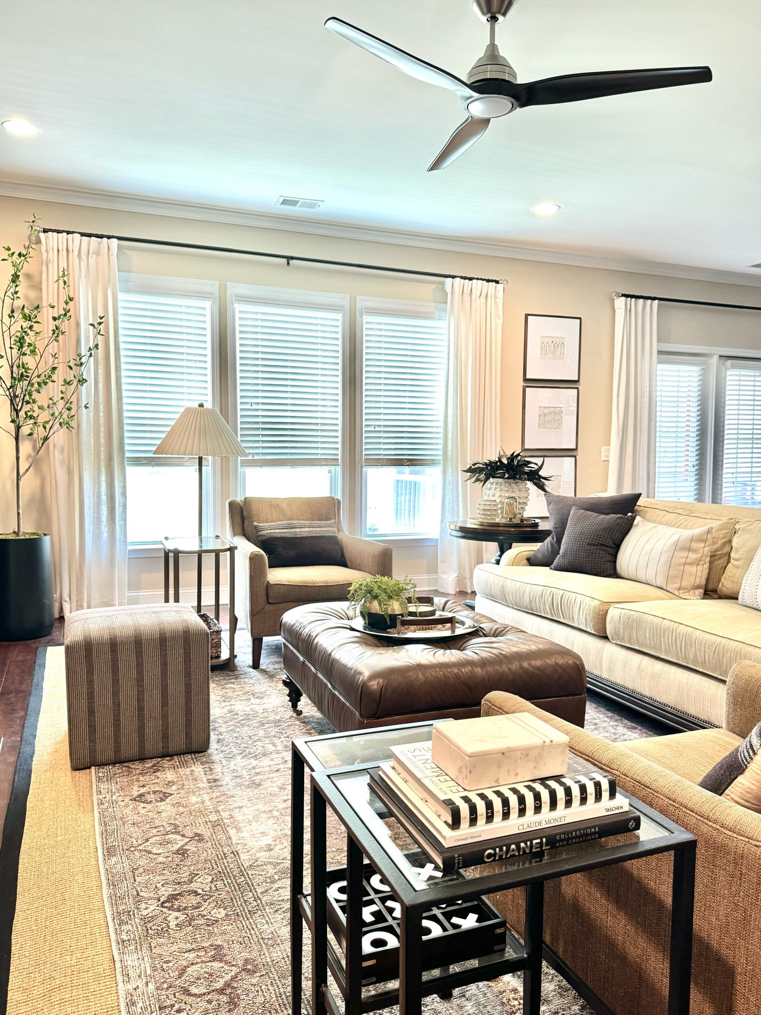 I strive for my living space to feel warm and inviting but also timeless and finished.
Layered rugs, a leather ottoman and greenery add softness to the room.

#LTKHome