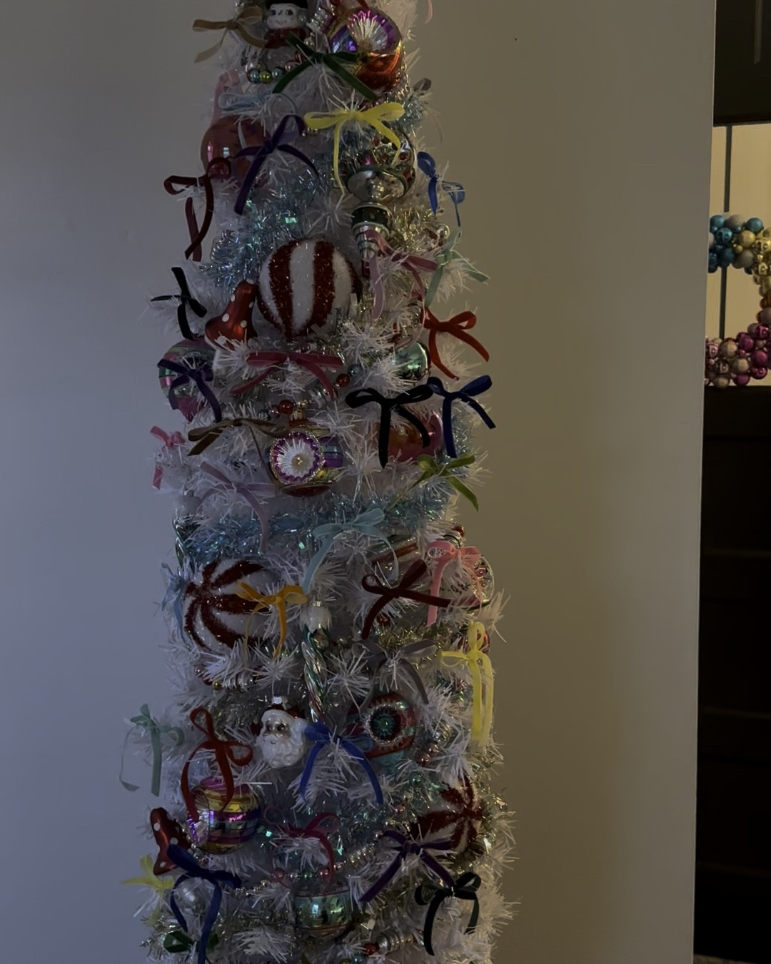 This is my skinny tree in my kitchen! It’s filled with all vintage shiny brite Christopher radko ornaments & multicolored velvet bows🎀🎀🎀
