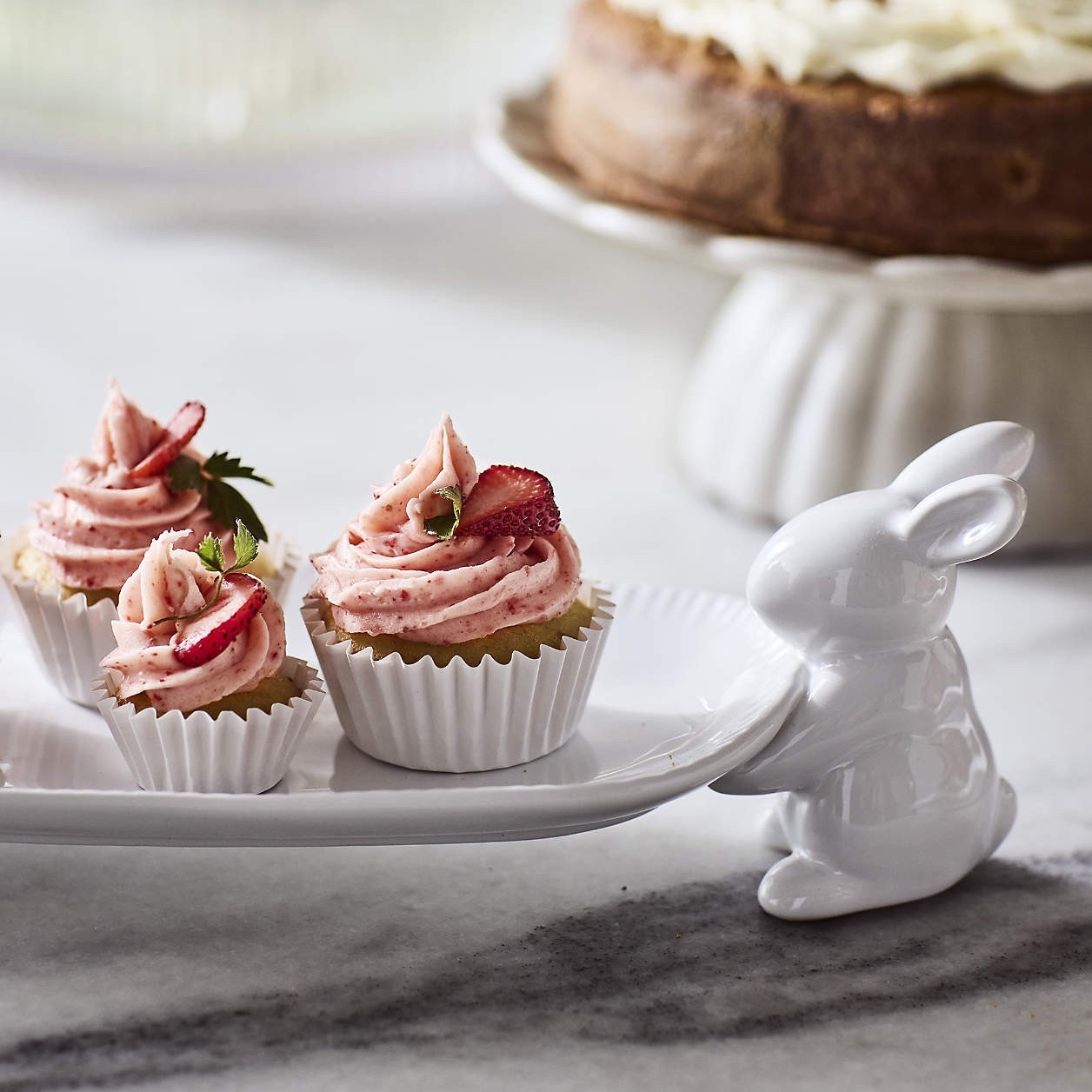 Two charming bunnies bring a touch of whimsy to your table as they carry an oval platter, perfect for serving petite pastries, fresh seasonal fruits, or roasted carrots. 🥕 Hand-glazed in a glossy white finish, this playful yet elegant platter adds a festive touch to any Easter buffet or springtime gathering. Delicate embossed fluting along the edge enhances its charm, making it a delightful blend of modern and whimsical design. A perfect centerpiece for seasonal entertaining, this ceramic serving plate also makes a thoughtful gift for your holiday host. 🐇

#LTKHome #LTKParties #LTKSeasonal