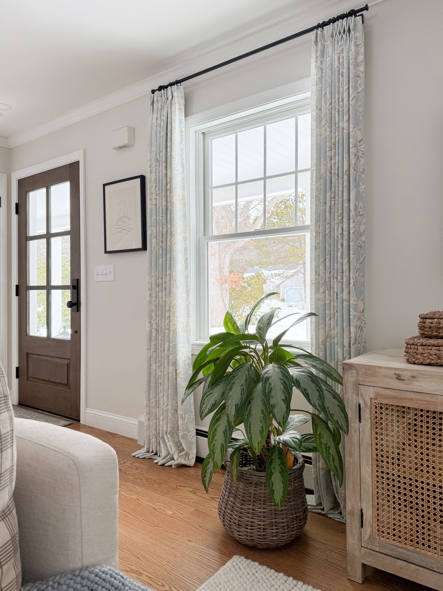 Coastal living room corner styled with woven basket planter, textured ivory rug, and layered neutral furniture for relaxed coastal home styling.

coastal living room styling

#LTKHome