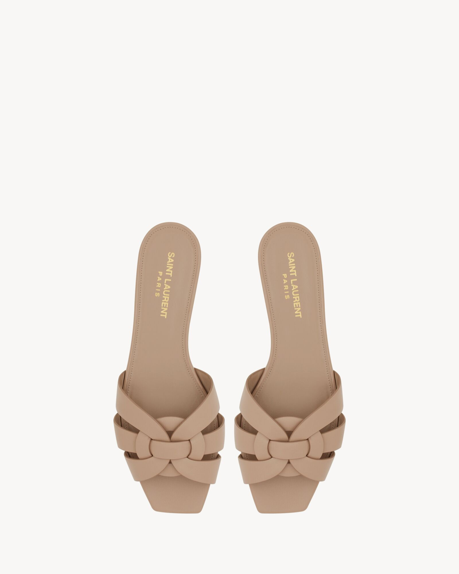 Slip-on flat mules with a square toe and intertwining straps. | Saint Laurent Inc. (Global)