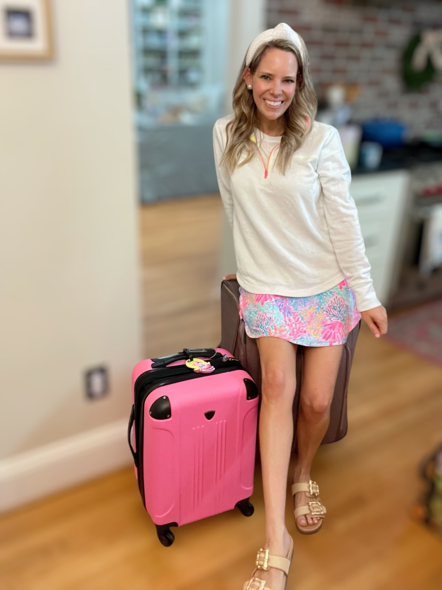 Code ASHLEYBA for 10% off Melinda Maria jewelry — grab your passport and let’s go! ✈️ This comfy-chic travel day outfit is perfect for your next getaway. I’m wearing a lightweight pullover with neon trim, paired with a vibrant Lilly Pulitzer skort that brings all the tropical vibes!

Topped it off with a textured headband for an effortless hair day and my go-to Melinda Maria jewelry (use code above for 10% off!). My sandals are cute AND comfy with a gold chain detail — ideal for airport security.

My hot pink carry-on is giving major Barbiecore energy while keeping things super functional with spinner wheels and a hard shell!
	•	Pullover: Lightweight with pop trim
	•	Skort: Lilly Pulitzer-inspired print
	•	Shoes: Neutral chain slide sandals
	•	Headband: Quilted textured bow
	•	Jewelry: Melinda Maria (necklace + earrings)
	•	Luggage: Pink hardshell carry-on

Travel tip: Always pack a pullover for chilly flights!

#TravelStyle #AirportOutfit #MelindaMariaJewelry #LTKSpringBreak #BarbiecoreLuggage #LillyPulitzerStyle #GetawayReady #ComfyAndCute #LTKunder100 #ResortStyle #GrabYourPassport #LTKstyletip


#LTKTravel #LTKFindsUnder50 #LTKFindsUnder100