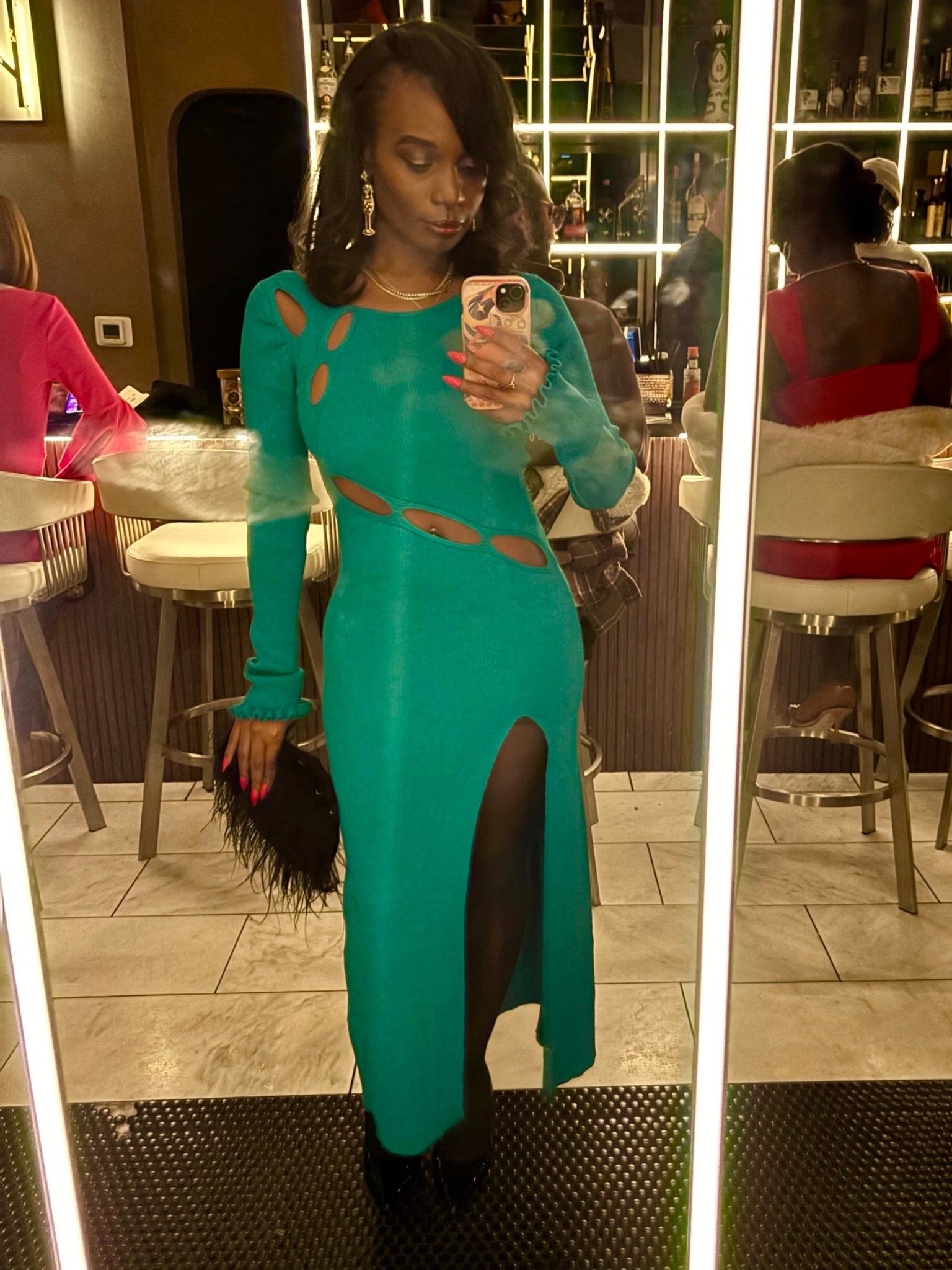 Sizzling hot on a cold night in this winter girls night out outfit. Featuring cutout knit dress, feather purse, and champagne glass earrings. 

#LTKootd #LTKSeasonal #LTKdayinmylife