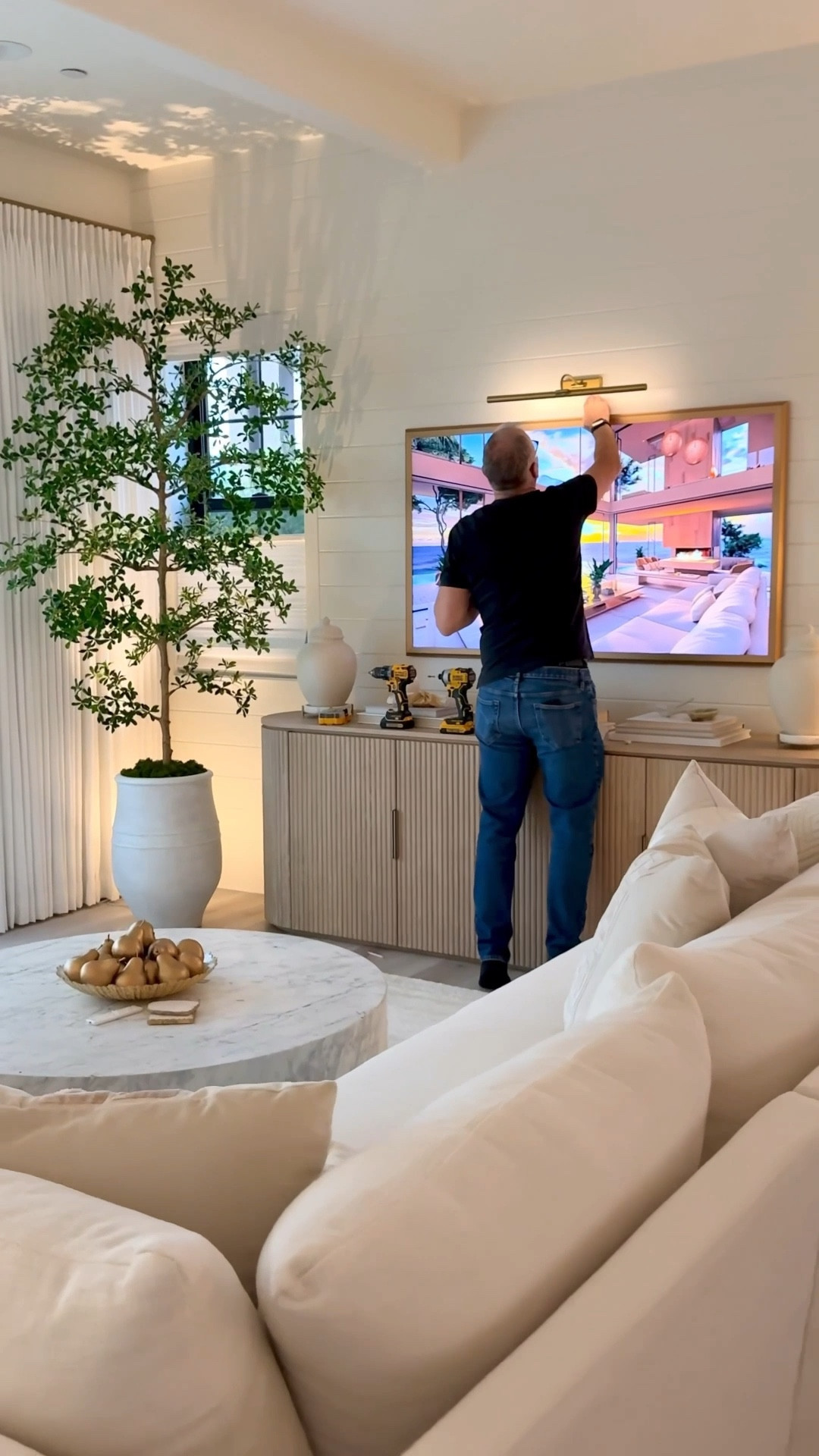 Favorite picture lights we use in our home. ✨
We have a mix of battery operated and hardwired picture lights and love all! In our kitchen, we have the 18” cabinet maker hardwired light and everywhere else we have battery operated. They’re simple to charge and I love that they come in 3 different lighting temperatures and you’re able to increase and lower the brightness level and set the lights on a timer so they go on every night when you want.

Sizing:
Over Mirror: 16” - plated gold matches my mirror
Over the art: 20” - plated gold 
Over TV: 24” (we have a 65” TV) - brass

Tree: I have the 8 foot shady lady tree and I painted my pot a little lighter, using Sherwin-Williams alabaster paint  


#LTKSaleAlert #LTKHome