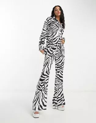 Public Desire x Paris Artiste satin shirt and flared pants set in zebra print | ASOS (Global)