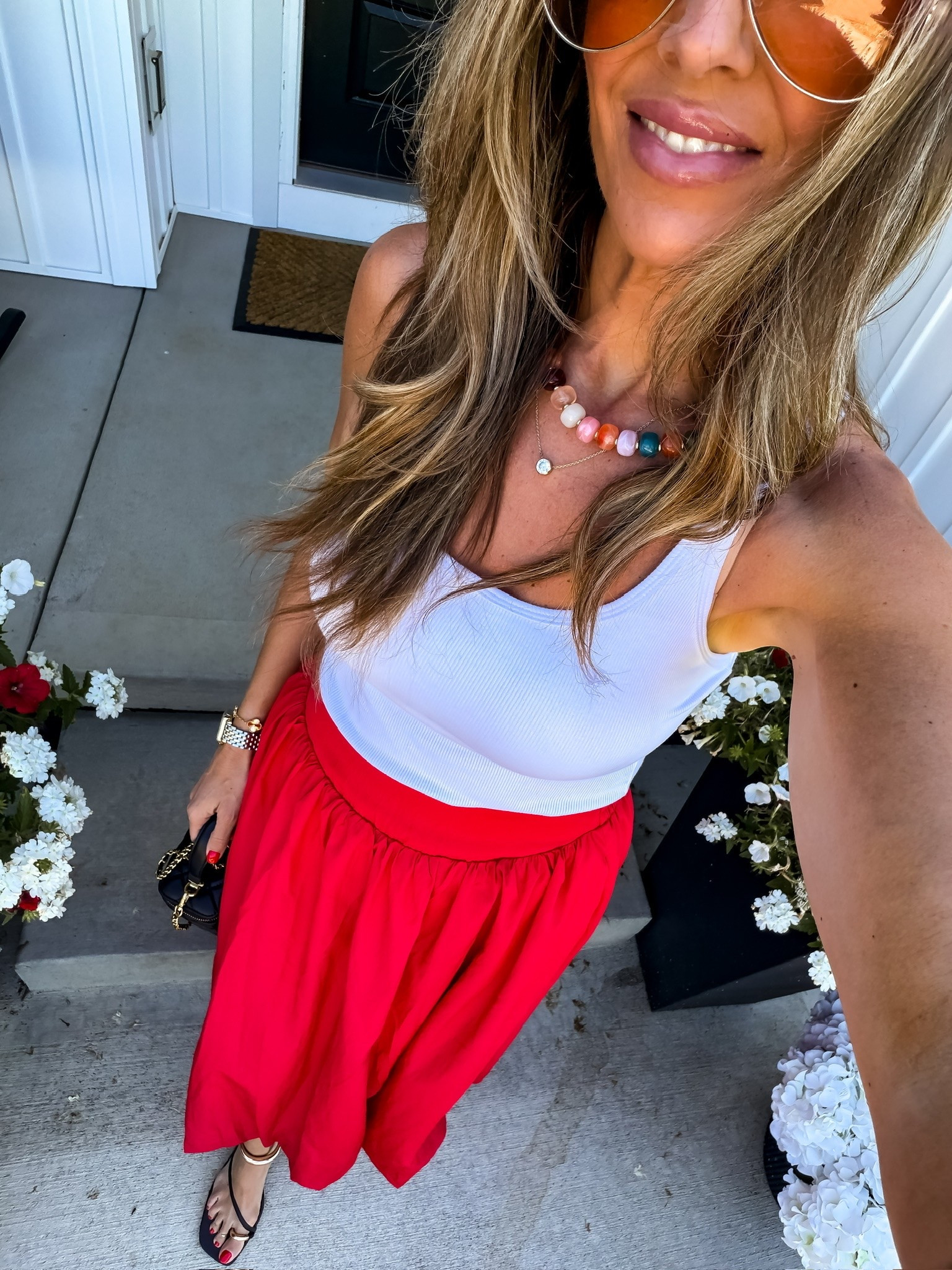 This red skirt is such a fun statement piece for summer! Paired with a simple white tank and colorful accessories, it creates an effortless outfit that looks far more expensive than it is. The flowy fit is comfortable, flattering, and perfect for everything from summer outings to vacation dinners.

Red skirt outfit, Summer outfit idea, White tank outfit, Colorful accessories, Vacation style, Summer fashion, Statement skirt, Casual chic outfit, Everyday style, Summer wardrobe, Affordable fashion, Vacation outfit, TheMomInStyle

#LTKootd #LTKmomlife #LTKOver40