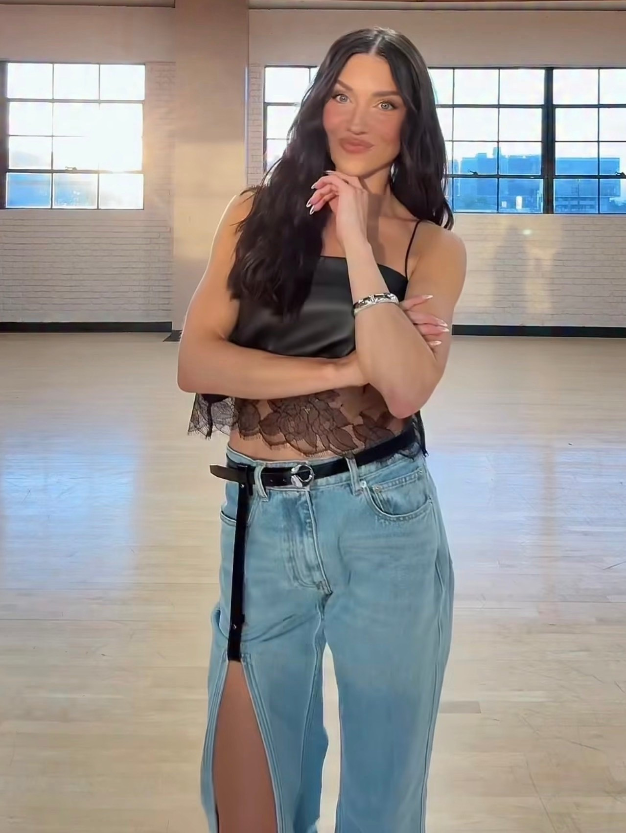 Jenna Johnson Chmerkovskiy black Camisole Lace Detailed Leather Top denim pants are cut with a straight, elongated leg and a suspended front panel that creates a vertical slit. The waistband remains clean and precise, allowing the suspended detail to define the silhouette for a distinct, architectural piece.